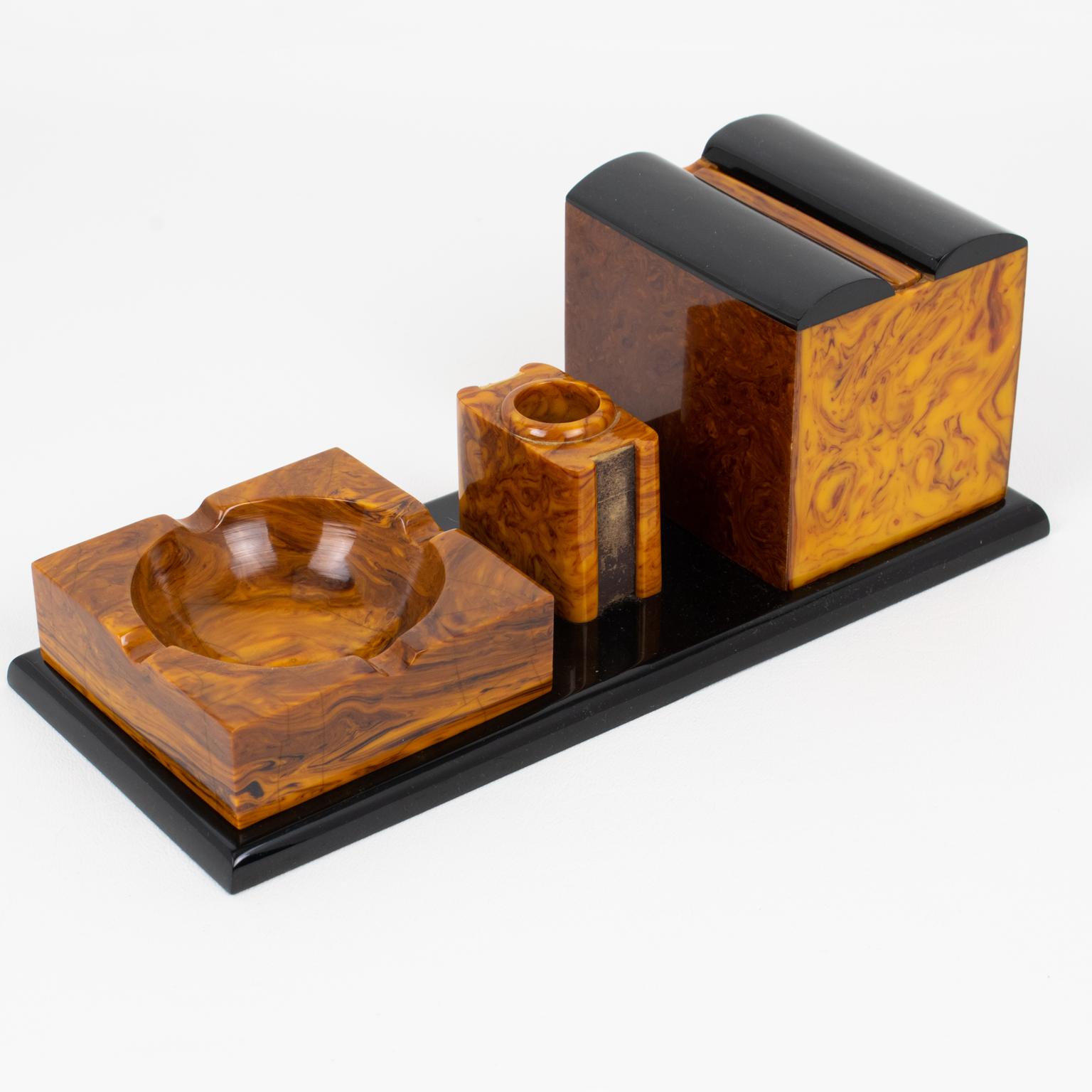 This stunning Art Deco Bakelite smoking ensemble is the perfect piece for collectors. The piece was crafted in France circa 1930. The all-in-one tobacco accessory features a cigarette dispenser, a match holder and scratcher, and an ashtray, all