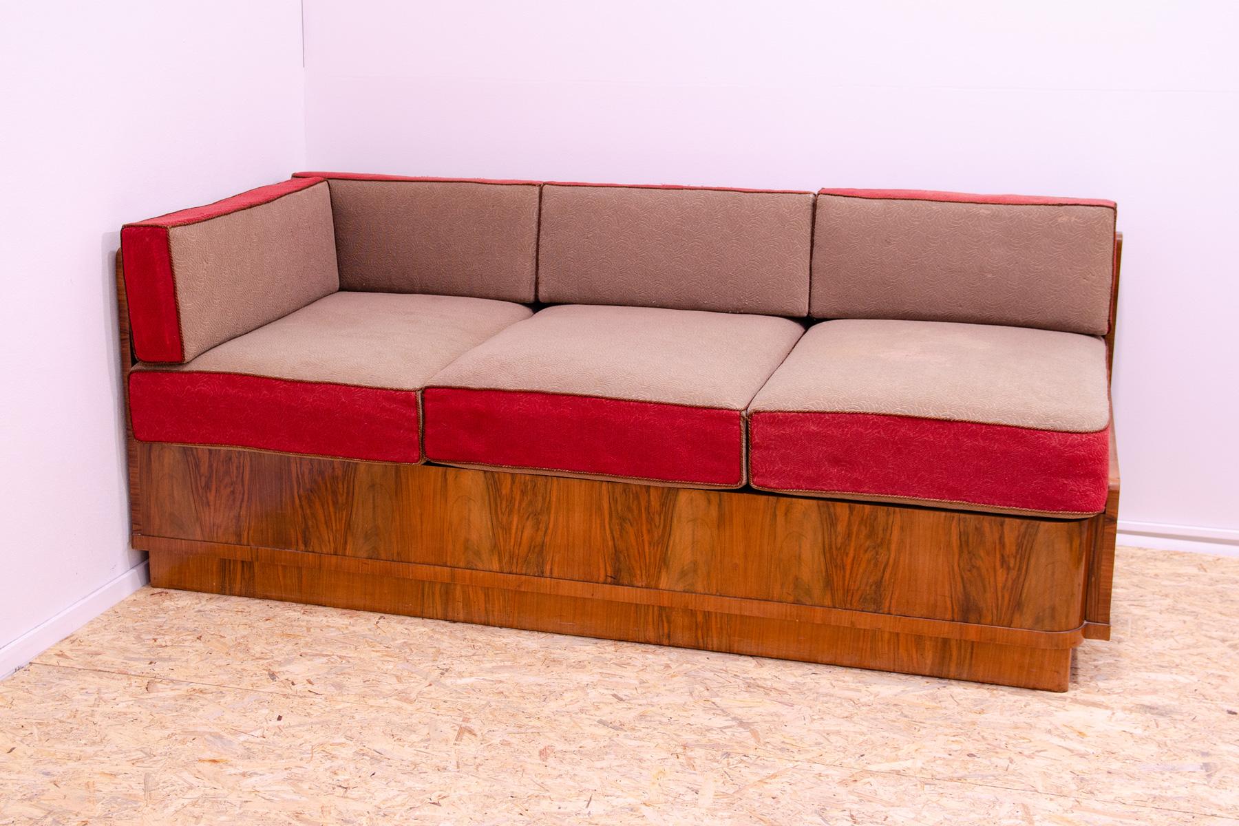 This ART DECO style sofa with a storage space was designed and made in the 1930´s in the former Czechoslovakia.
This simple design fits into the context of the design creation in Czechoslovakia between 1930´s-1950´s.
It features a walnut veneer that