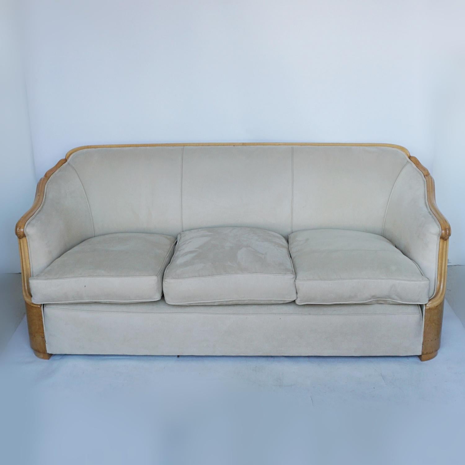 An Art Deco three seat sofa by Maurice Adams. Burr walnut wrap around veneers with satinwood banding and hand carved detail. Re-upholstered in Alcantara suede. 

Dimensions: H 74cm W 180cm D 80cm 

Origin: English

Date: Circa 1930

Item