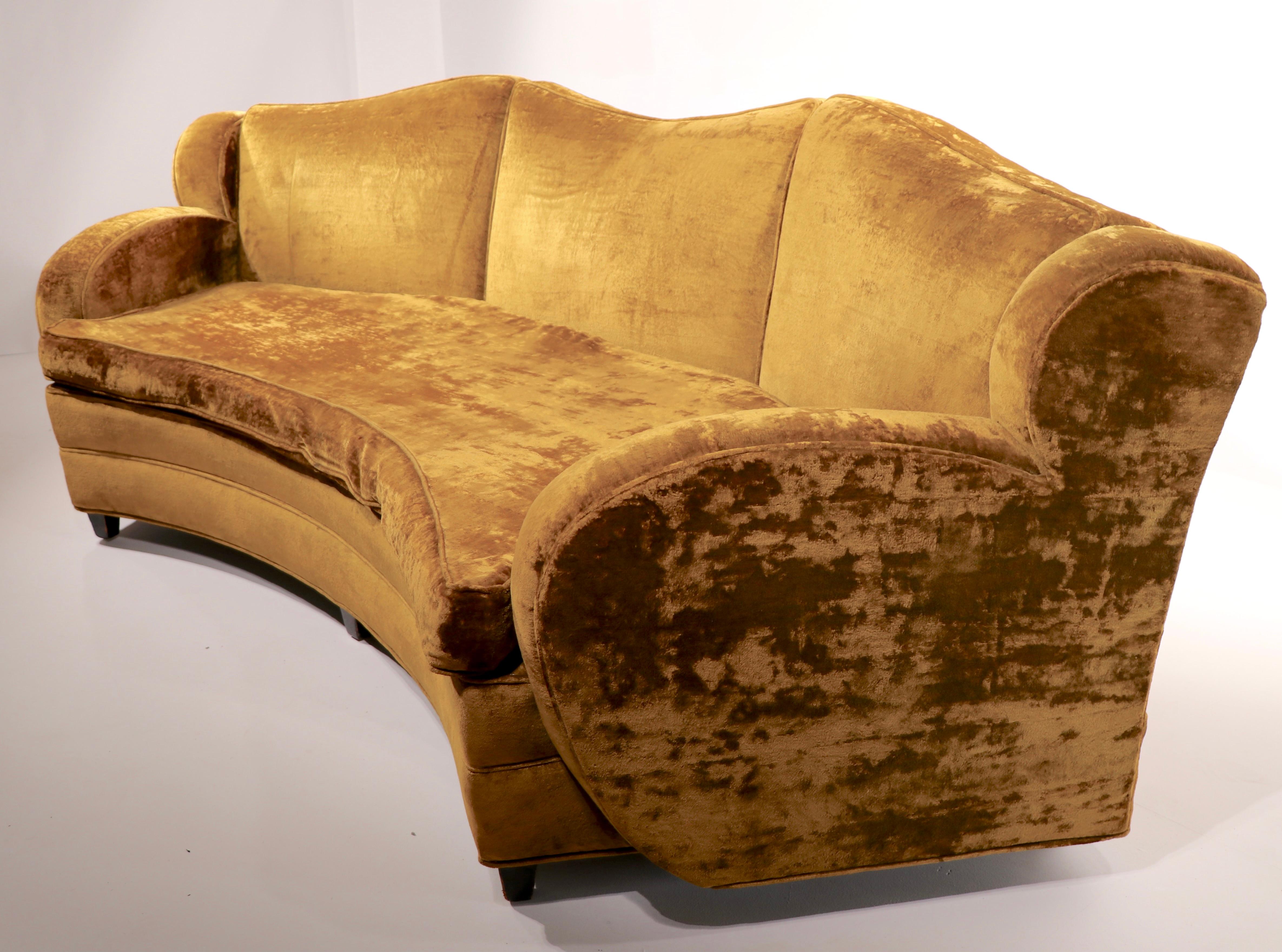 Totally Glam Hollywood Regency, Art Deco sofa. Top quality construction, tied spring upholstery, solid wood frame. structurally sound, and sturdy, fabric is worn, and will need to be replaced ( reupholstered ). Semi circular curved shape adds to the