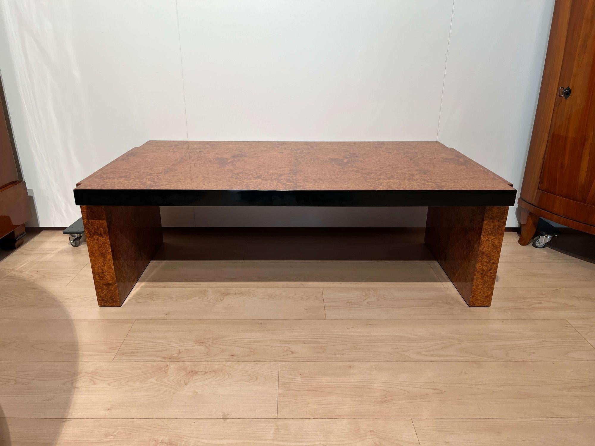 Low rectangular art deco sofa of coffee table from France about 1930.
Amboyna roots wood veneered and lacquered. Black lacquered at the edges.
Dimensions: H 40, 5 cm x W 122 cm x D 68 cm.