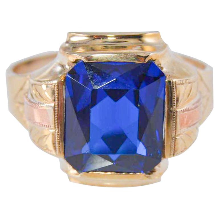 UNISEX RING
STYLE / REFERENCE: Art Deco Handmade Ring
METAL / MATERIAL: 10Kt. Solid Gold Yellow and Rose 
CIRCA / YEAR: 1930's
SIZE:  10.25

This great looking unisex ring is entirely handmade. The ring is set with a synthetic sapphire and is sized