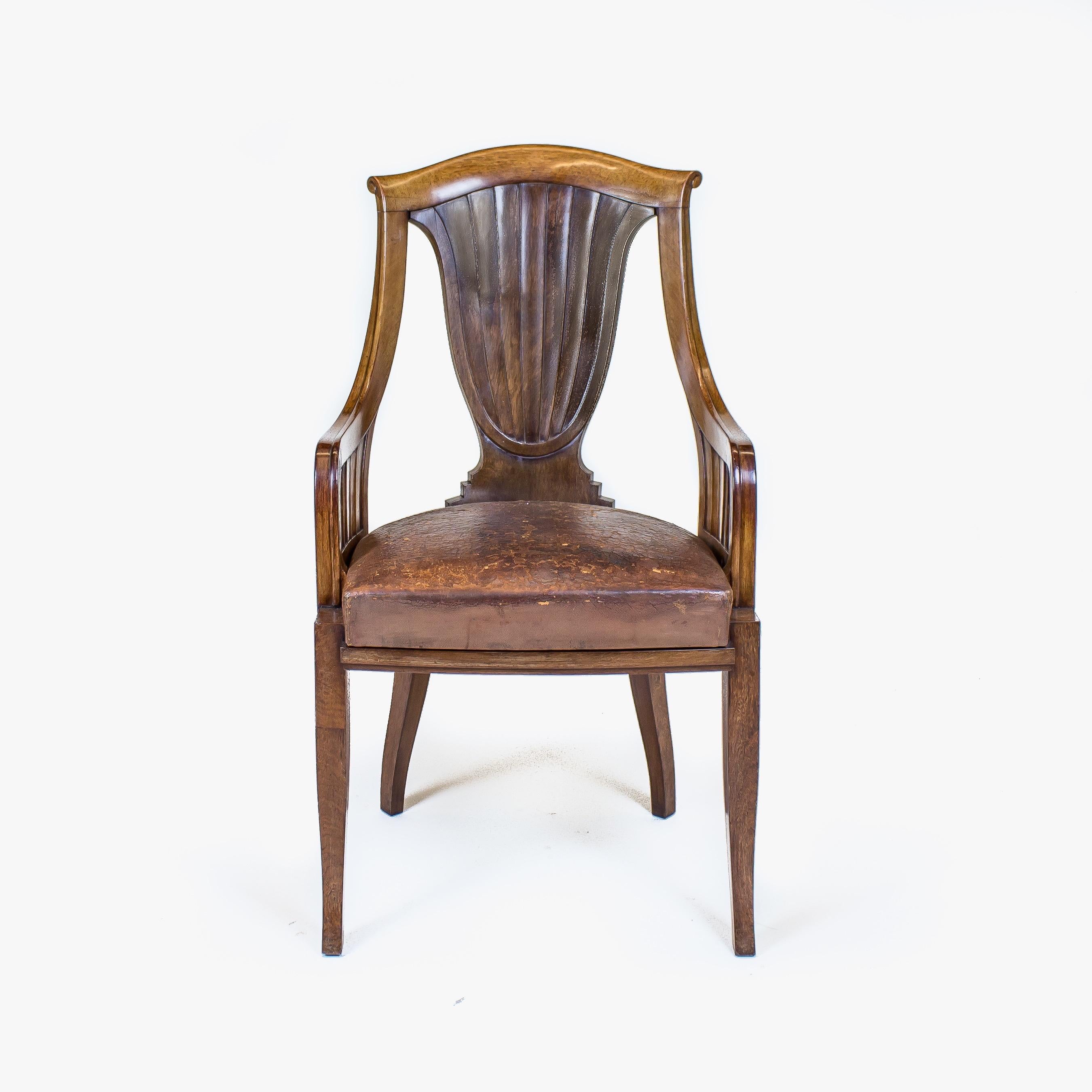 The ribbed vase splat back with an arched toprail with downswept arms on shaped legs. The seat with the original Cuban leather.

France, circa 1920.

Both the dust sheet and the chair frame signed 'Georges Roger Paris'.