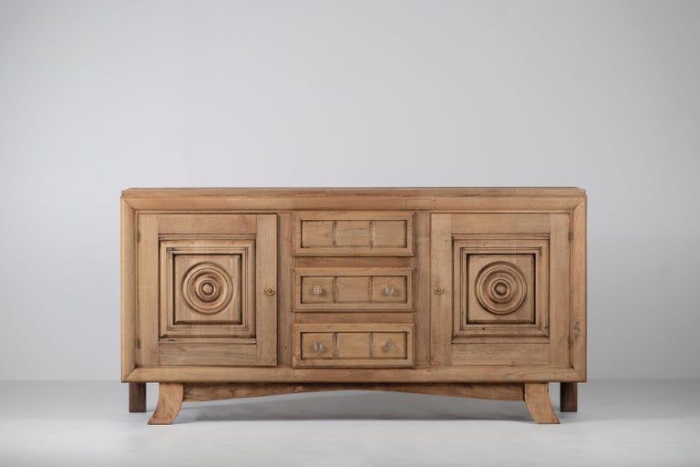 Very elegant Credenza in solid oak, France, 1940s.
Large Art Deco Brutalist sideboard. 
The credenza consists of two storage facilities and a central drawer column and covered with very detailed designed doors. 
Very elegant 
The refined wooden