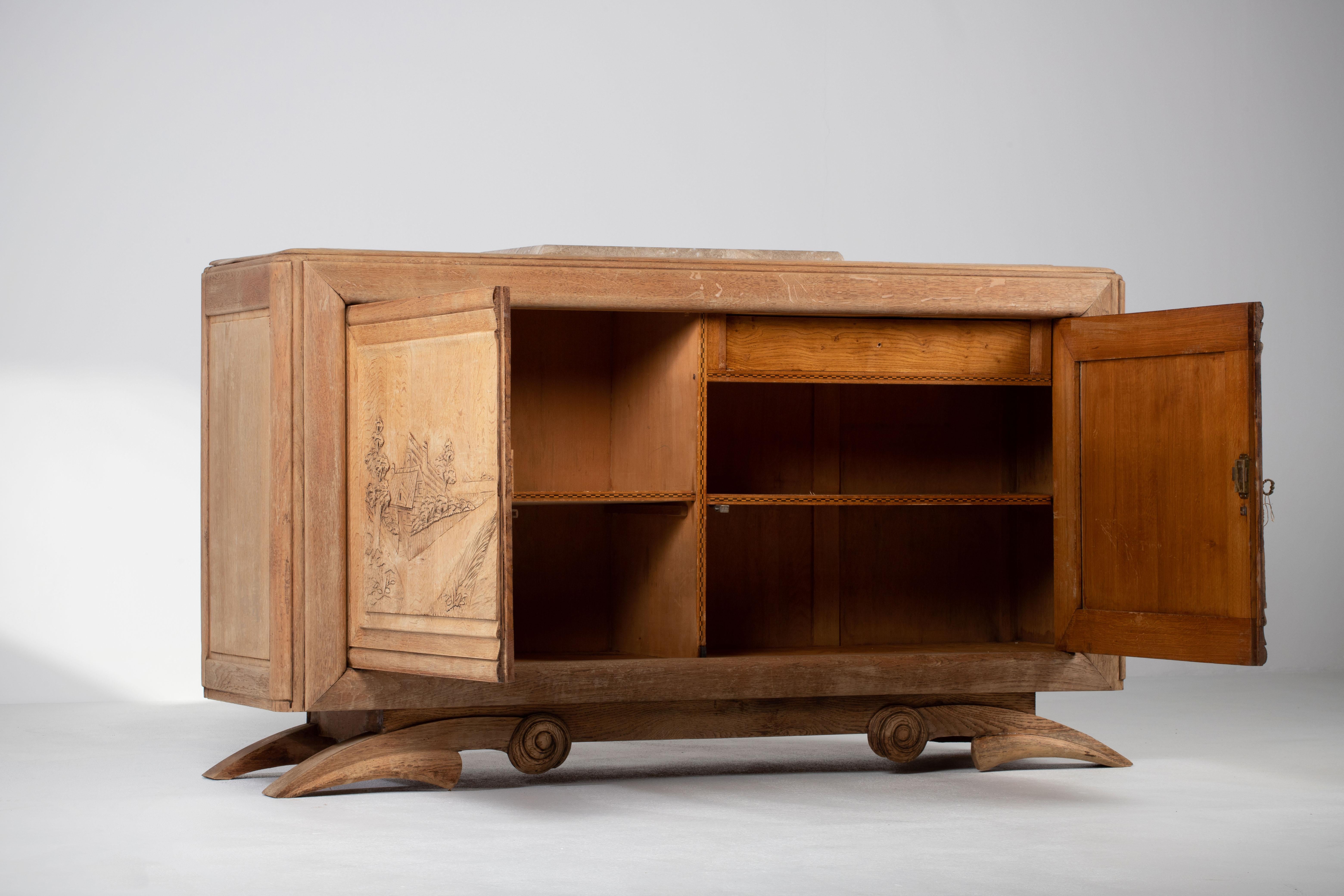 Credenza, solid oak, France, 1940s.
Large Art Deco Brutalist sideboard. 

This model was inspired the by the French duo Andre Domin and Marcel Genevriere, better known as Dominique's sideboard exhibited at the 'Exposition coloniale' in Paris in
