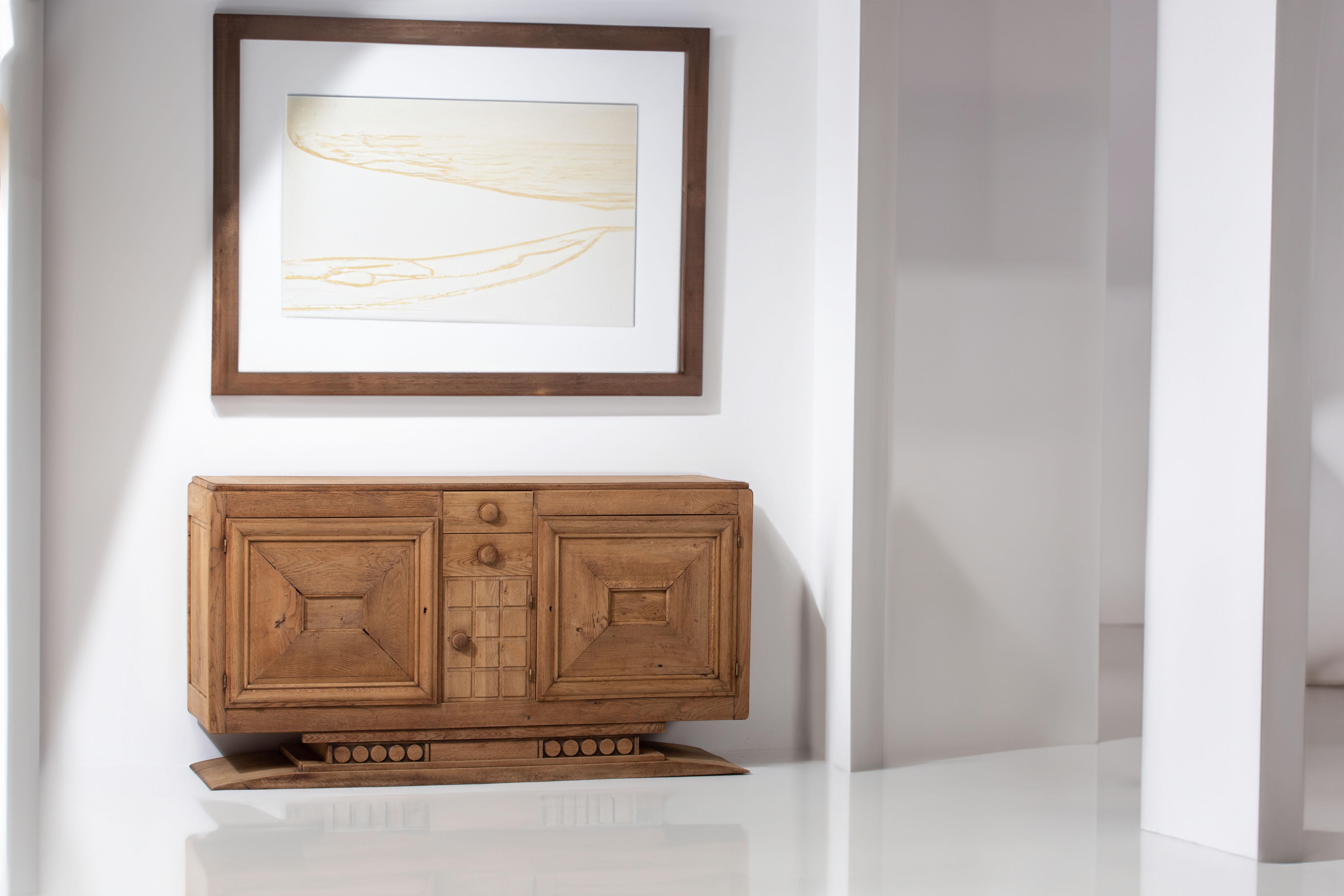 Introducing a captivating Art Deco credenza crafted in France during the 1940s. This impressive sideboard draws inspiration from the renowned French design duo Andre Domin and Marcel Genevriere, particularly their iconic sideboard showcased at the