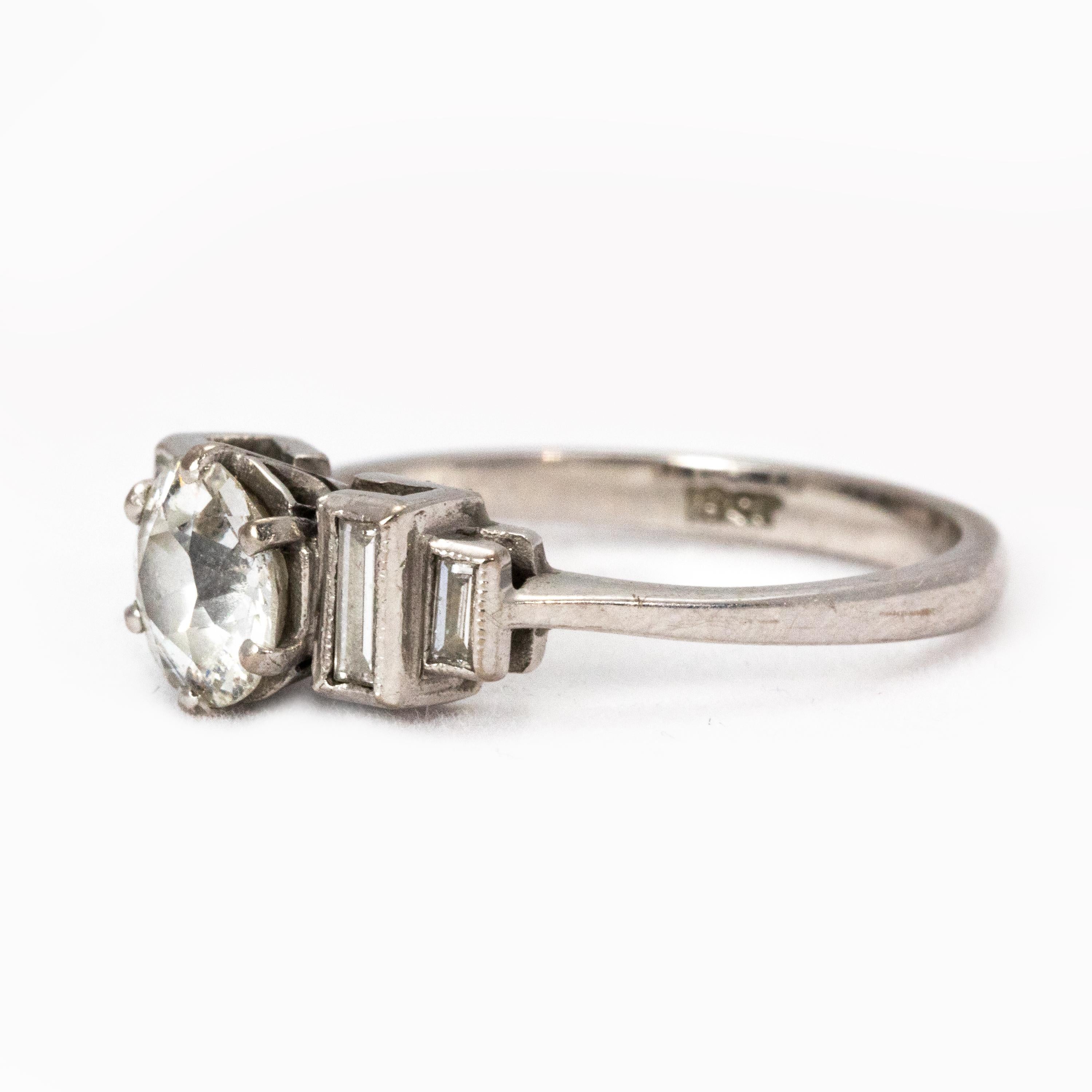 An elegant Art Deco era Solitaire Diamond Engagement ring. Hosting a bright central 1 ct 10 Old-European cut diamond, colour I and clarity SI2. Flanked by four exquisite tapering baguette diamonds, all set in 18 ct white gold.

Ring Size: N or 6 1/2