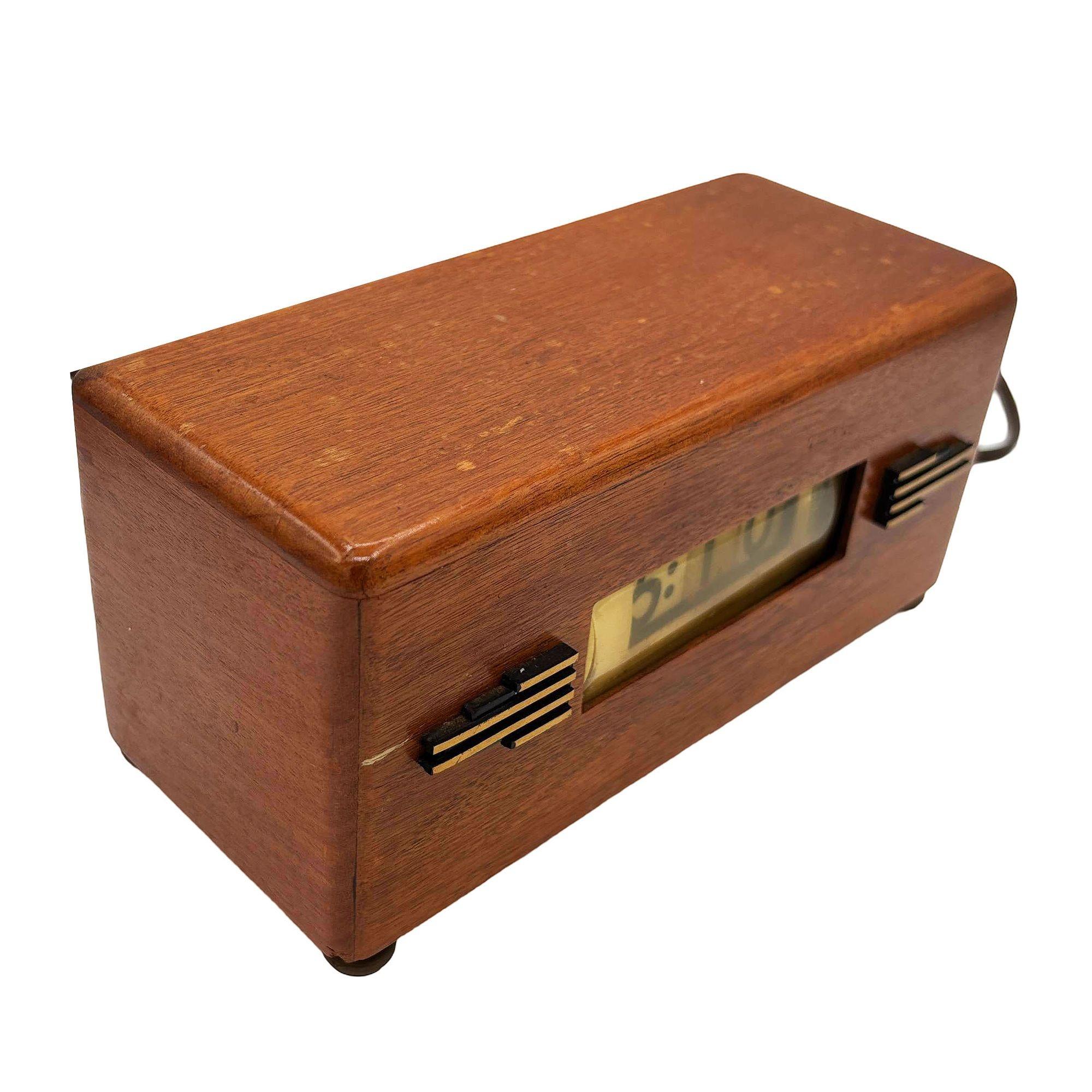 Art Deco model P-40 electric digital clock by Lawson. The clock is style 217 with a mahogany wood body, Streamline styled brass casted accents & feet, with a working seconds counter. The Lawson model # shows as 217- often referred to as the 