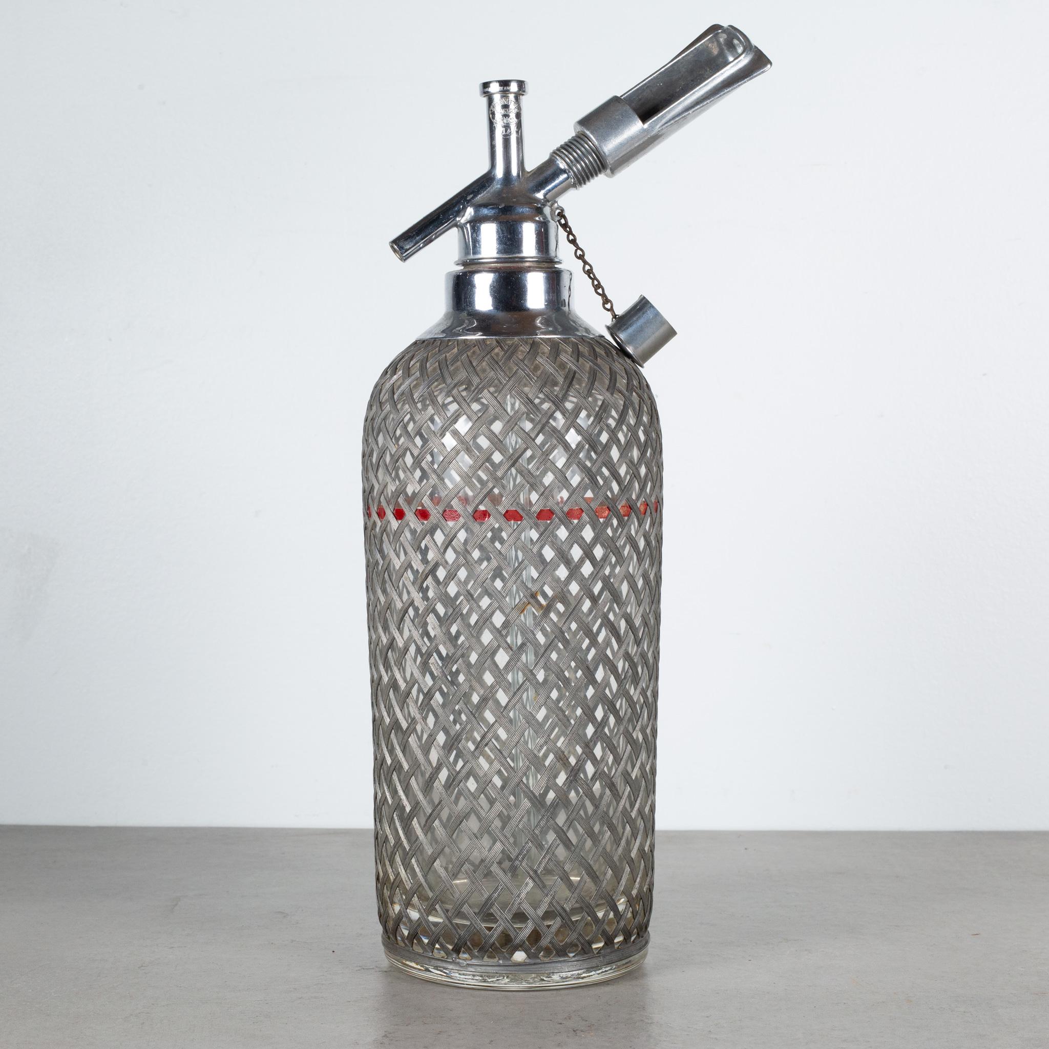 ABOUT

An original Art Deco Sparklets seltzer bottle. The thick glass bottle has a wire mesh cover sleeve, chrome mechanisms on top, a red fill line and etched 