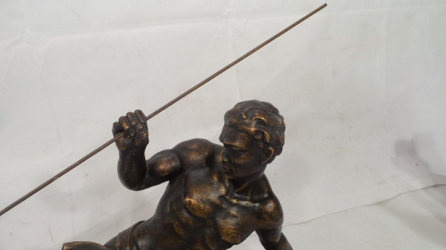 An outstanding original Art Deco figure signed by the renowned artist S Melani. The sculpture is of a powerful Olympiad Spear Thrower. In bronzed plaster set on a polished black marble base. This wonderful sculpture defines Power with its muscular