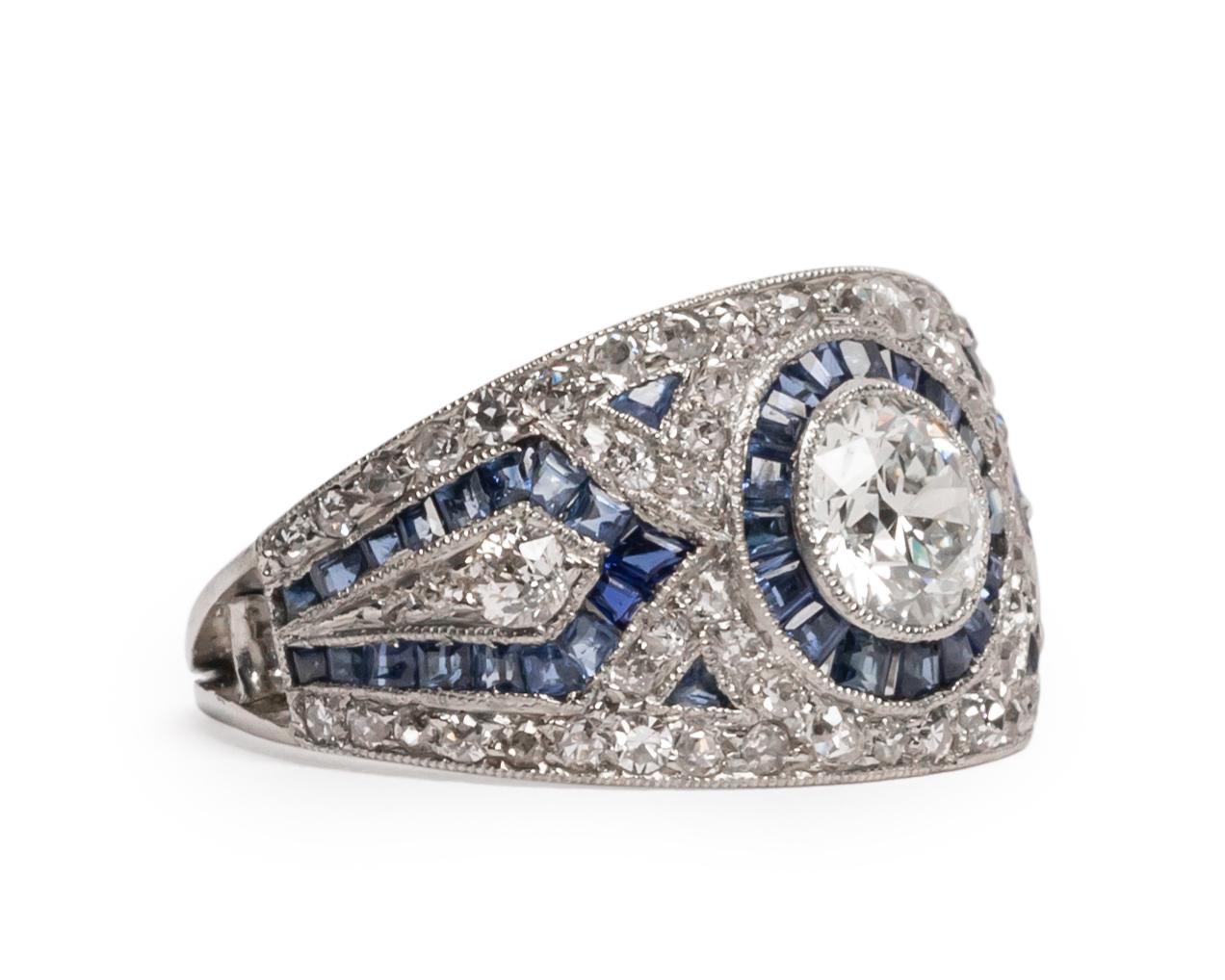 Here we have an beautiful example of an Art Deco era engagement ring! This genuine 1920's ring features a stunning intricate, geometric design in a highly detailed platinum ring. The beautifully crafted platinum ring is decorated with pave old cut