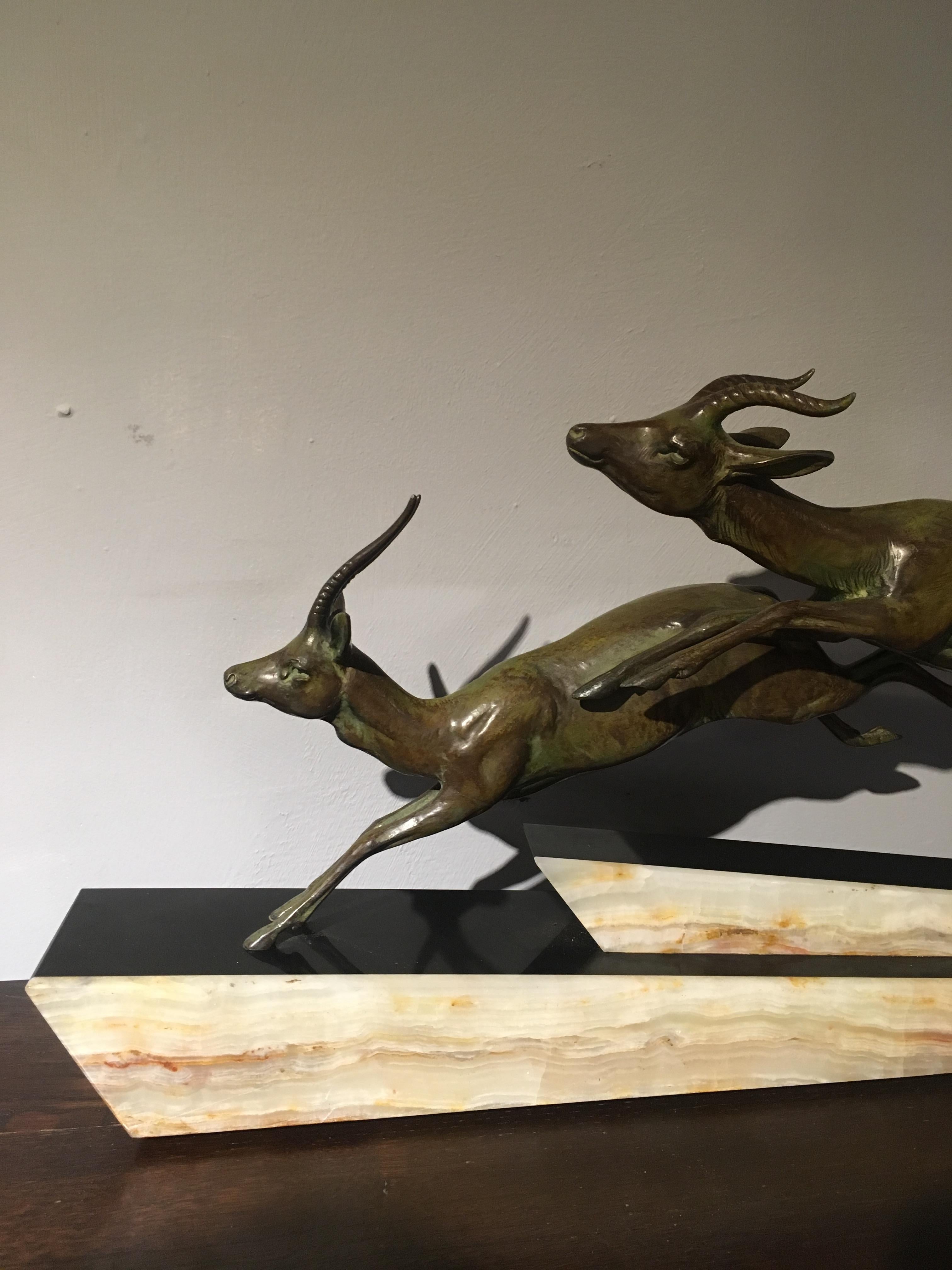 Nice Art Deco group of Antelope.

Mounted on a base of black Belgian slate and onyx , couple of minor chips to the base. 

Bearing the signature of Longfils.

Measures: Height 12 inches 
Width 26 inches 
Depth 4 inches.