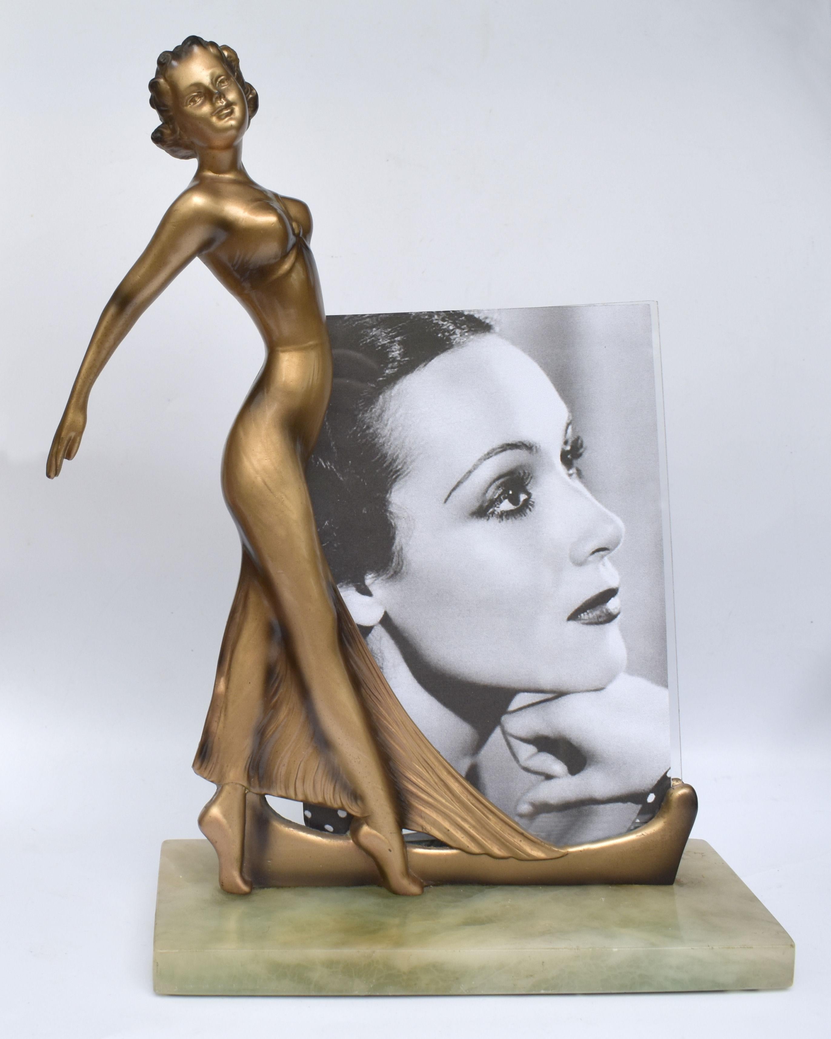 Standing 30 cm tall is this very glamourous Art Deco picture, one of which we haven't seen before. This lovely frame features an elegantly dressed Hollywood style lady made from cast spelter and cold painted, she acts as the support for two panes of