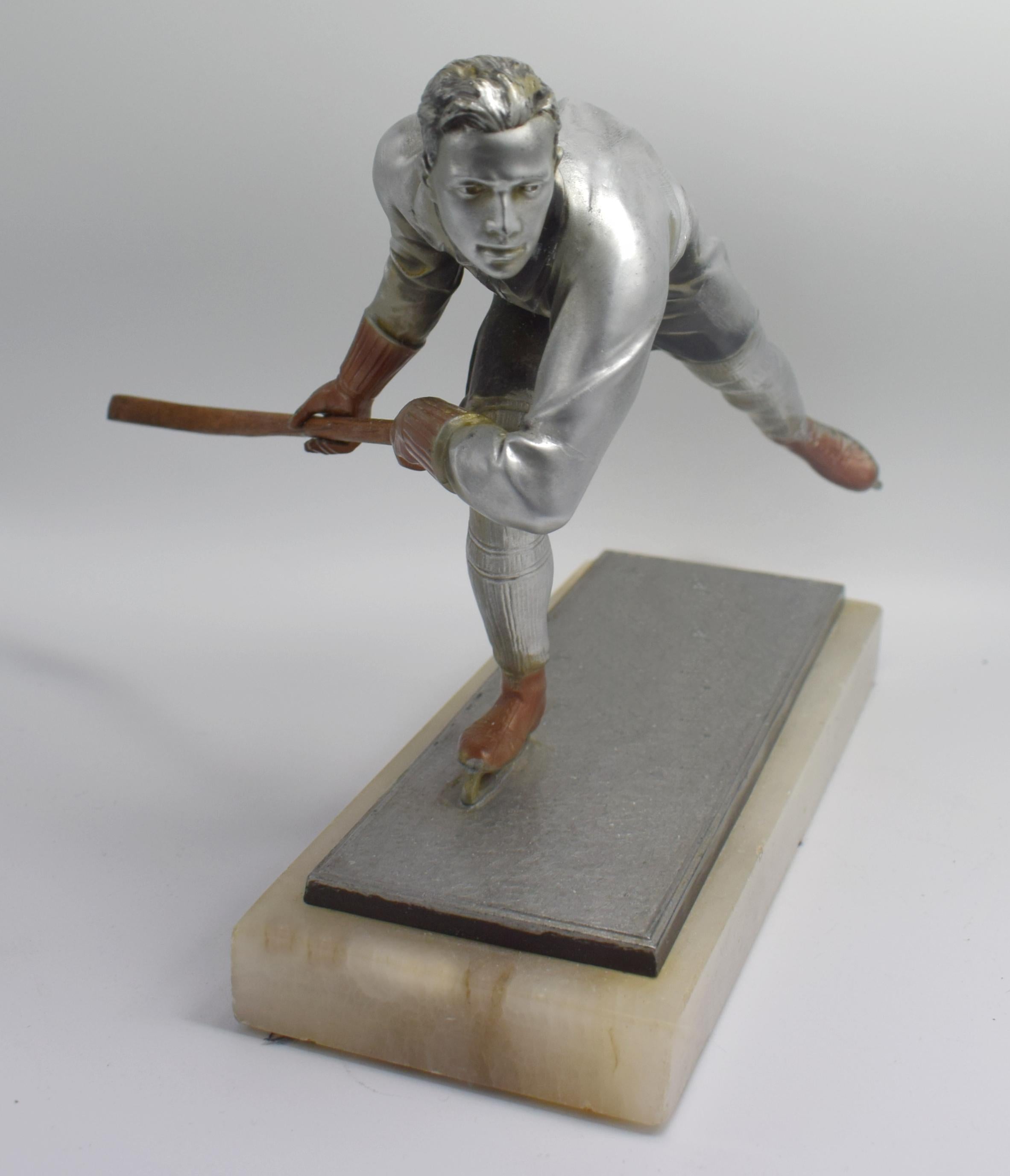 Beautifully detailed and crafted Art Deco male ice skater figure in silvered spelter dating to the 1930s. He's unsigned but attributed to Josef Lorenzl. From any angle he gracefully poses a movement. His condition is very good with minimal signs