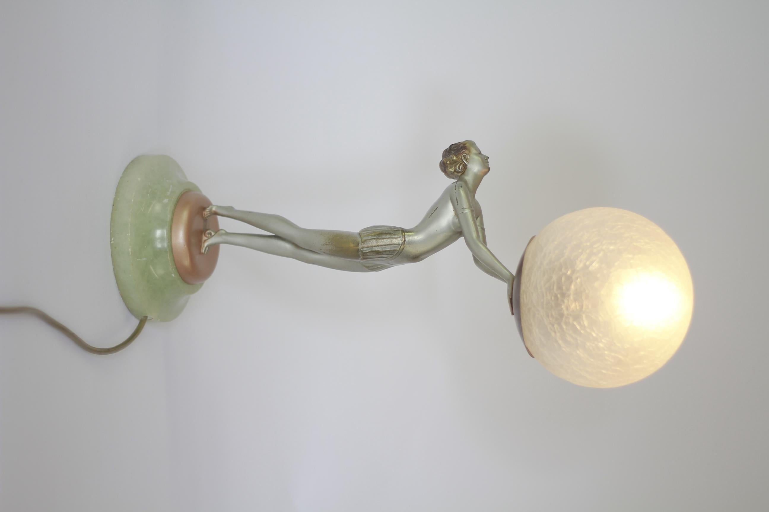 Art Deco Spelter Lady Lamp in the Manner of Lorenzl circa 1930s
Silver & gold in colour,
Spelter with circular Alabaster base, 
Recently Re wired & pat tested,
in the Manner of Josef Lorenzl [ no signature]
Replaced repro crackle glazed glass