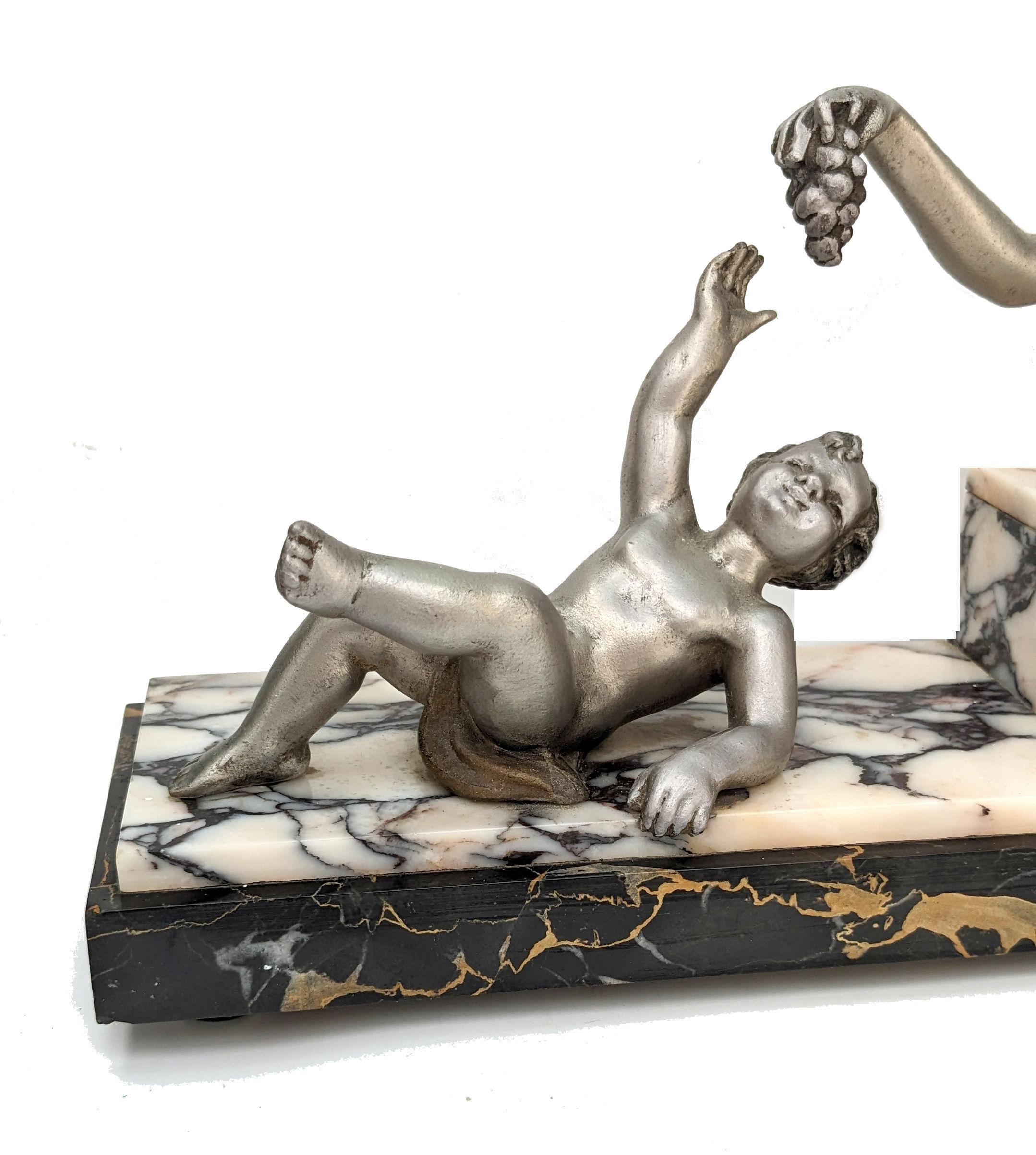 For your consideration is this large French figural group on a tri coloured sold marble base, dating to the 1930's. Features a female out stretched offering grapes to a cherub young boy. Made from spelter and gilded on top in soft tones of silver,