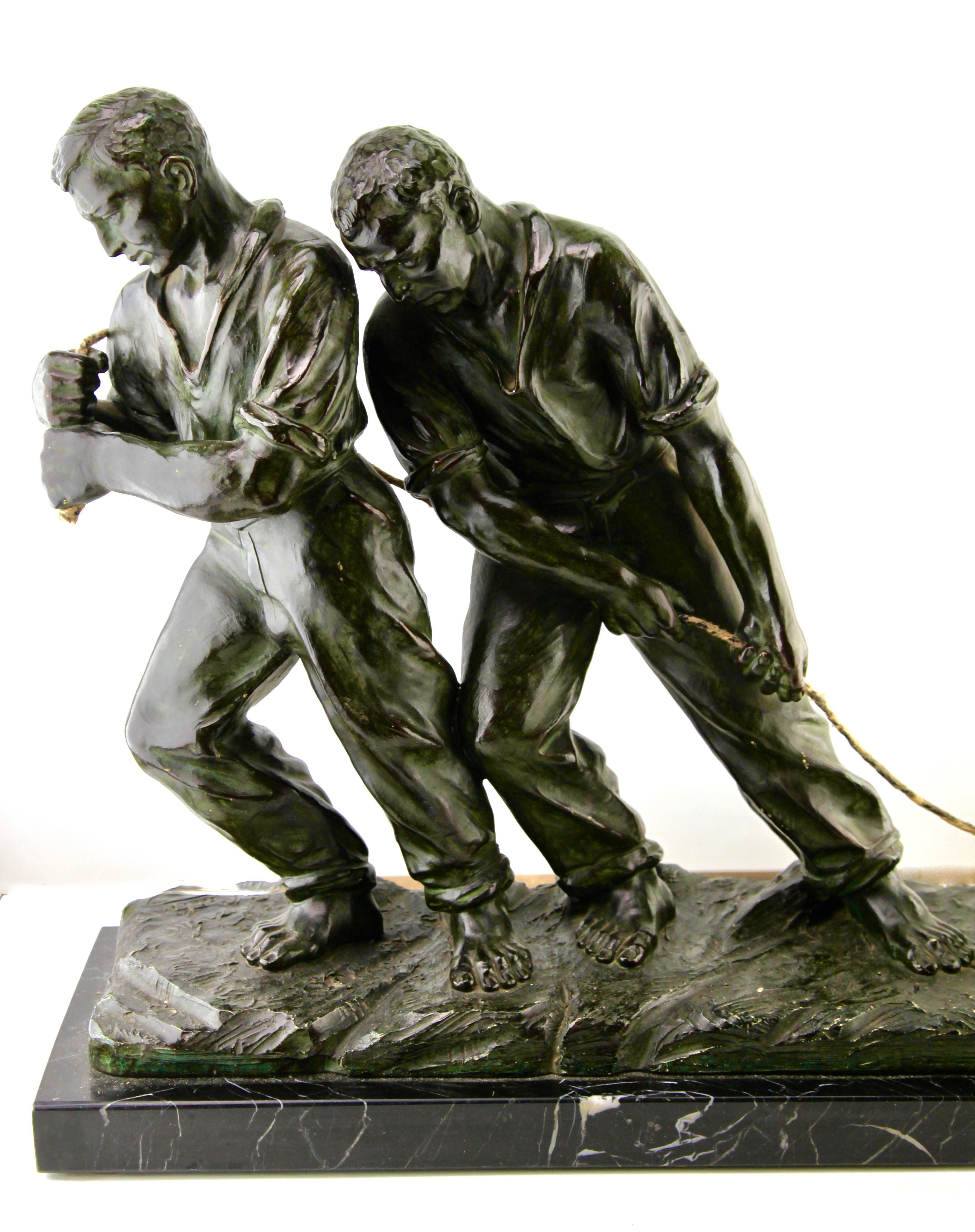 French Art Deco Spelter Sculpture, Two Men Pulling a Boat from the Water Signed G Carli For Sale
