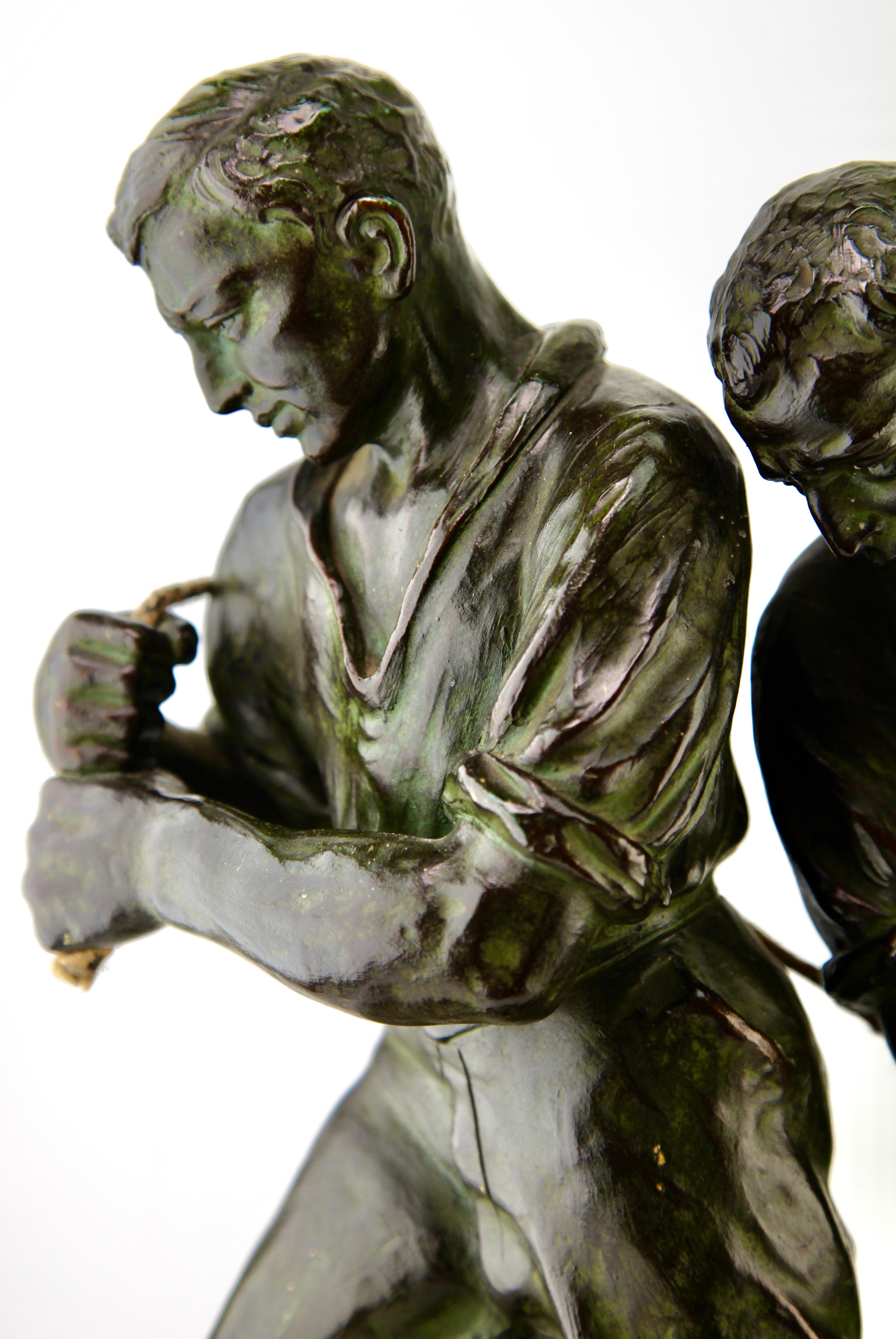 Faceted Art Deco Spelter Sculpture, Two Men Pulling a Boat from the Water Signed G Carli For Sale