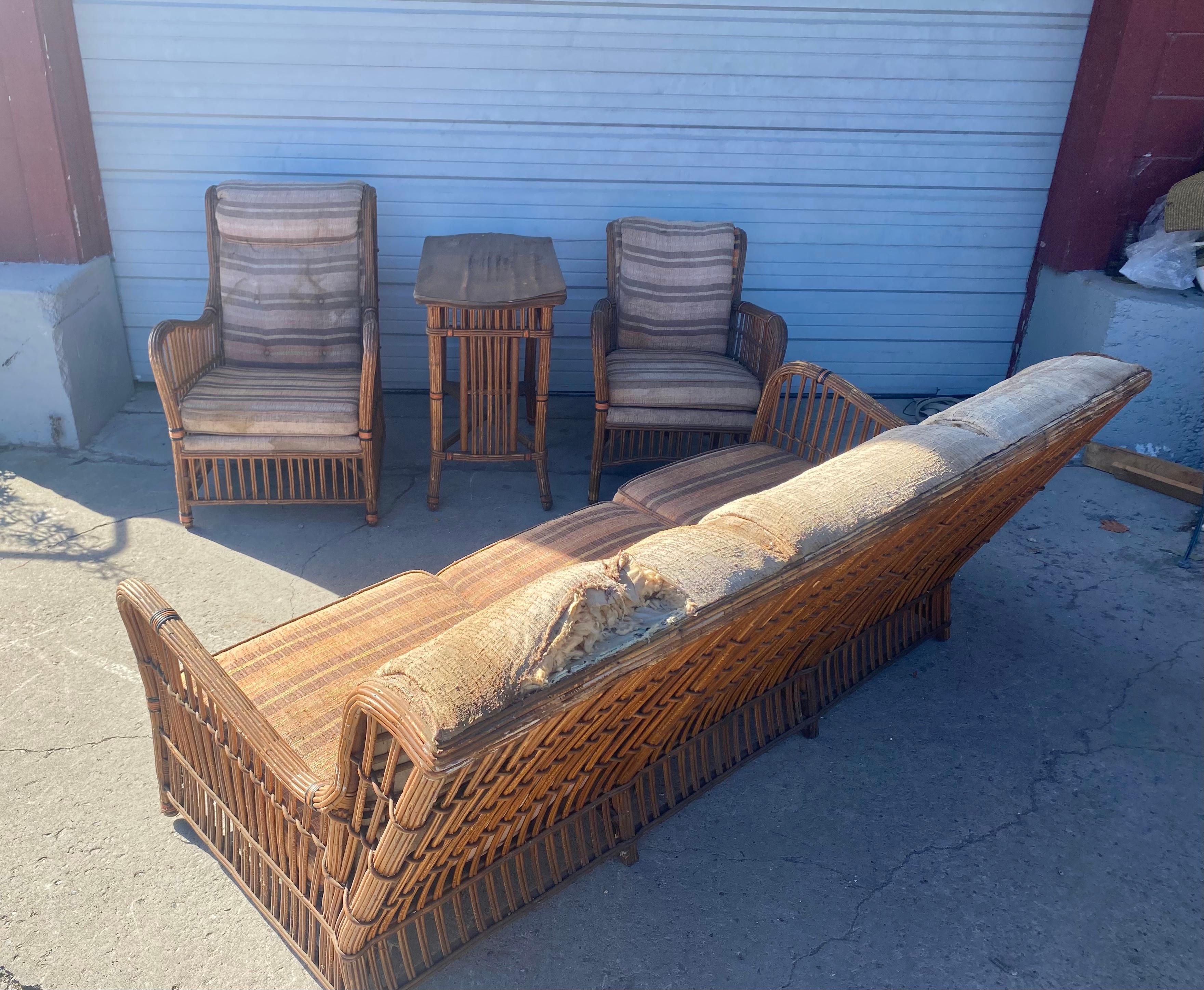 Art DECO split reed / stick wicker 4 piece seating, and table, Unusual design. Set consisting of his and hers lounge chairs, sofa and lamp table. Orininal condition, missing some orange rap, (bottom legs). Retains original upholstery. Very unusual