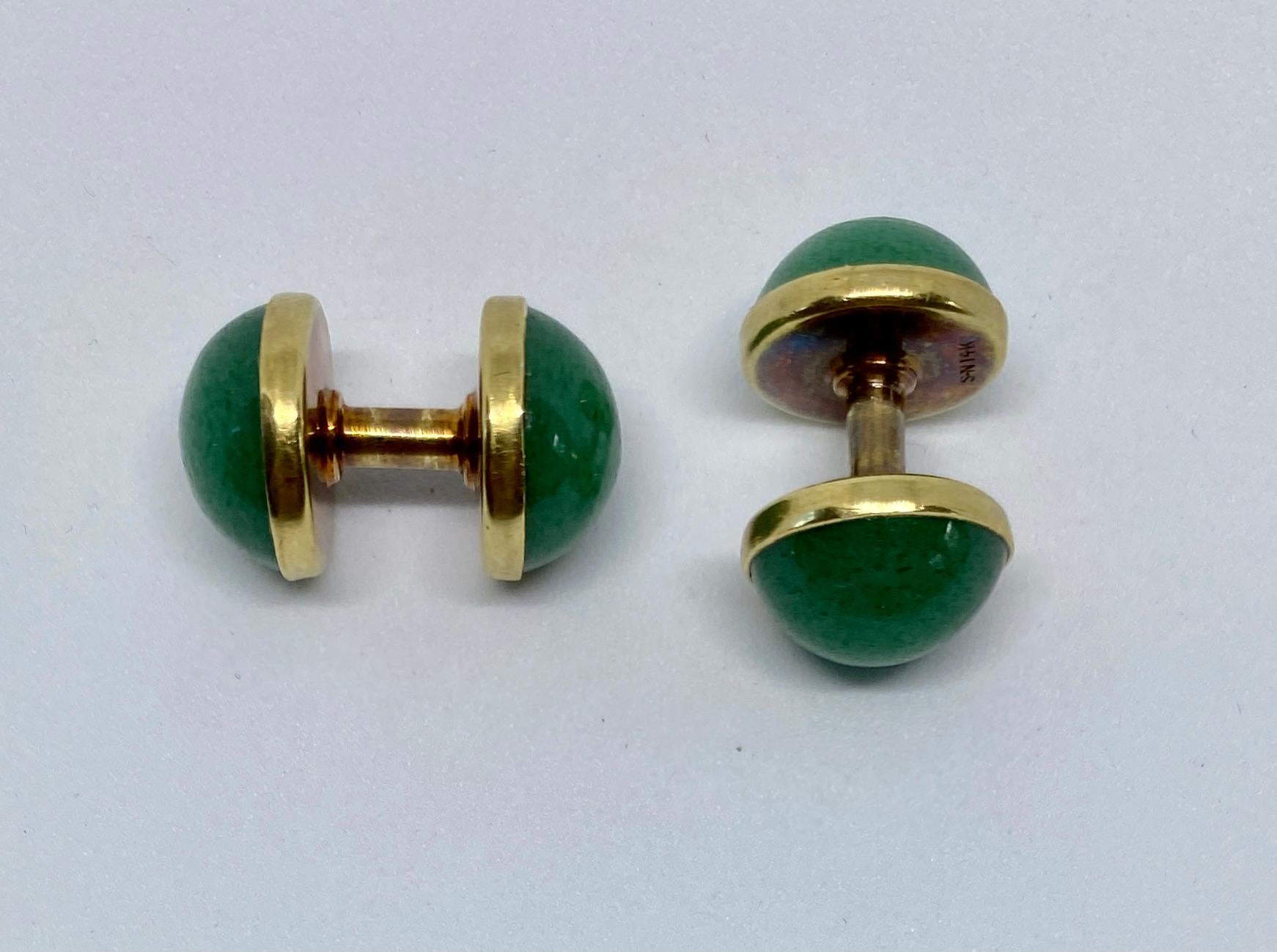 Fantastic, extremely rare cufflinks featuring green aventurine cabochons set in 14K yellow gold by Sansbury & Nellis, a top American producer of jewelry from the Art Deco era.

Spool-style cufflinks are very easy to put on and remove - essentially,