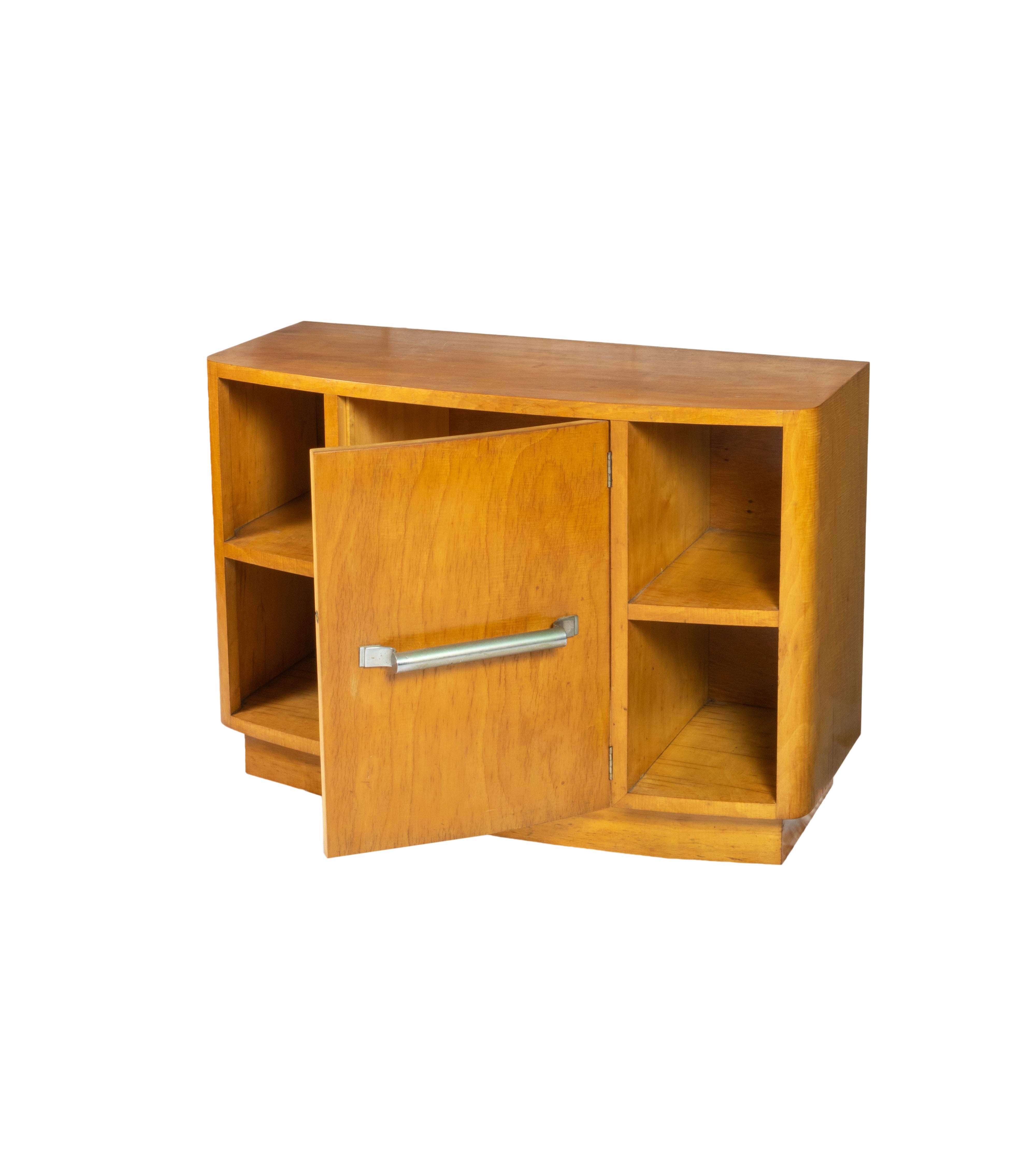 An elegant spruce wood light color support piece with four bookcases and a large door. 
Small piece with tin hardware.
Order, color, geometry, words that define the Art Deco world.
In Portugal examples like this one were created for refurbishing the