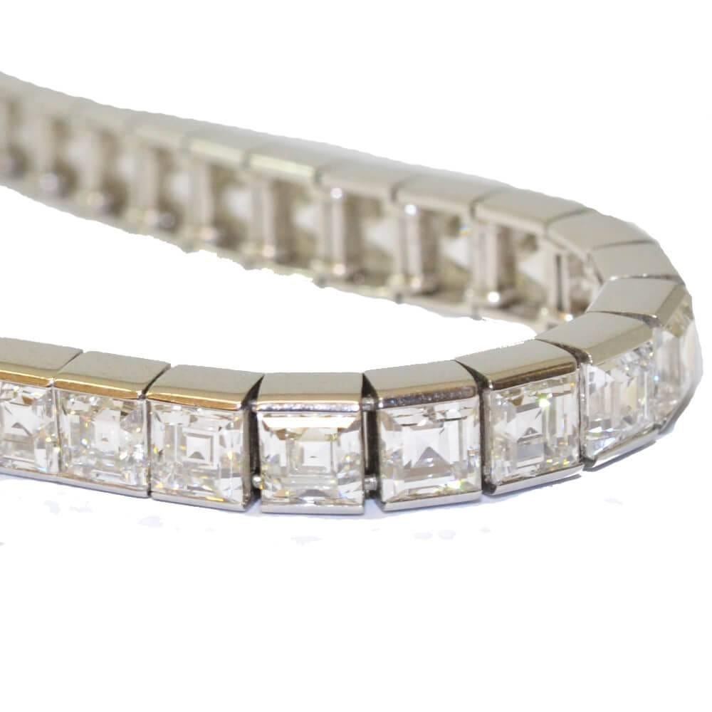 Art Deco square baguette cut diamond line bracelet. The very slightly graduated diamonds are mounted in platinum. American, circa 1925.