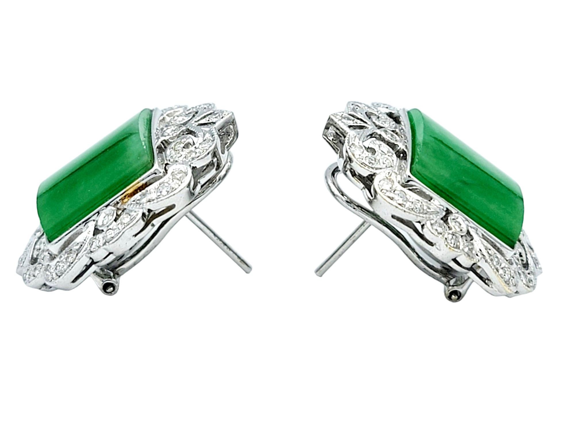 This elegant pair of jadeite and diamond earrings, set in lustrous 18 karat white gold, are a true work of art. The focal point of each earring is a captivating square cabochon jadeite, exuding a rich green hue that symbolizes tranquility and