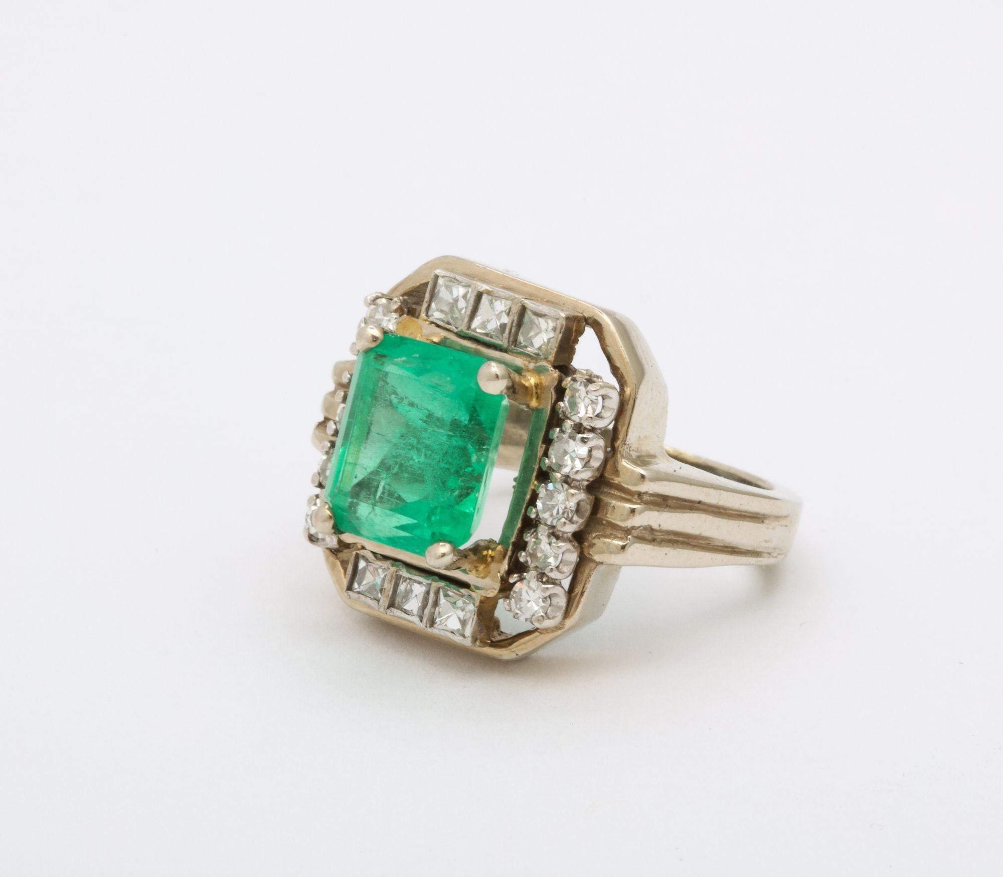 A beautiful Art Deco Square Cut Emerald Ring approximately 2.5 ct surrounded by square cut and round diamonds. 