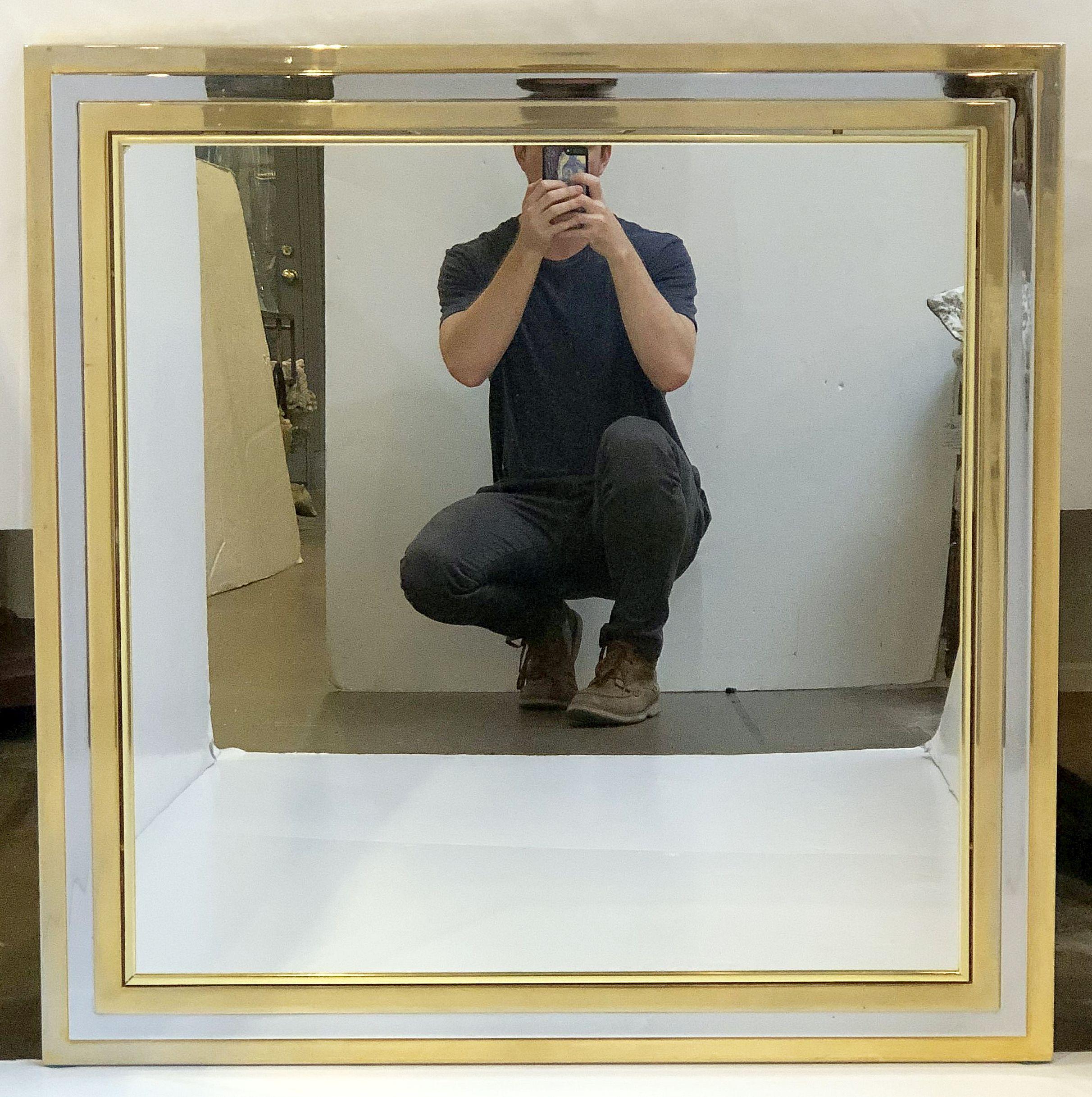 A fine large English square dressing or hall mirror in the Art Deco style featuring a stylish frame of brass and chrome.

Dimensions are H 35 1/2 inches x W 35 1/2 inches