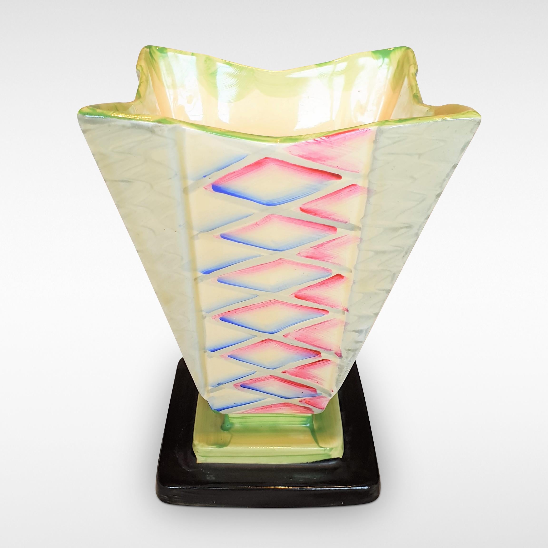 A stunning pattern in zingy colors on a dramatic shape, this Art Deco square vase from circa 1935 by Myott Son & Co is complete with the original 'frog' to assist flower arrangement.