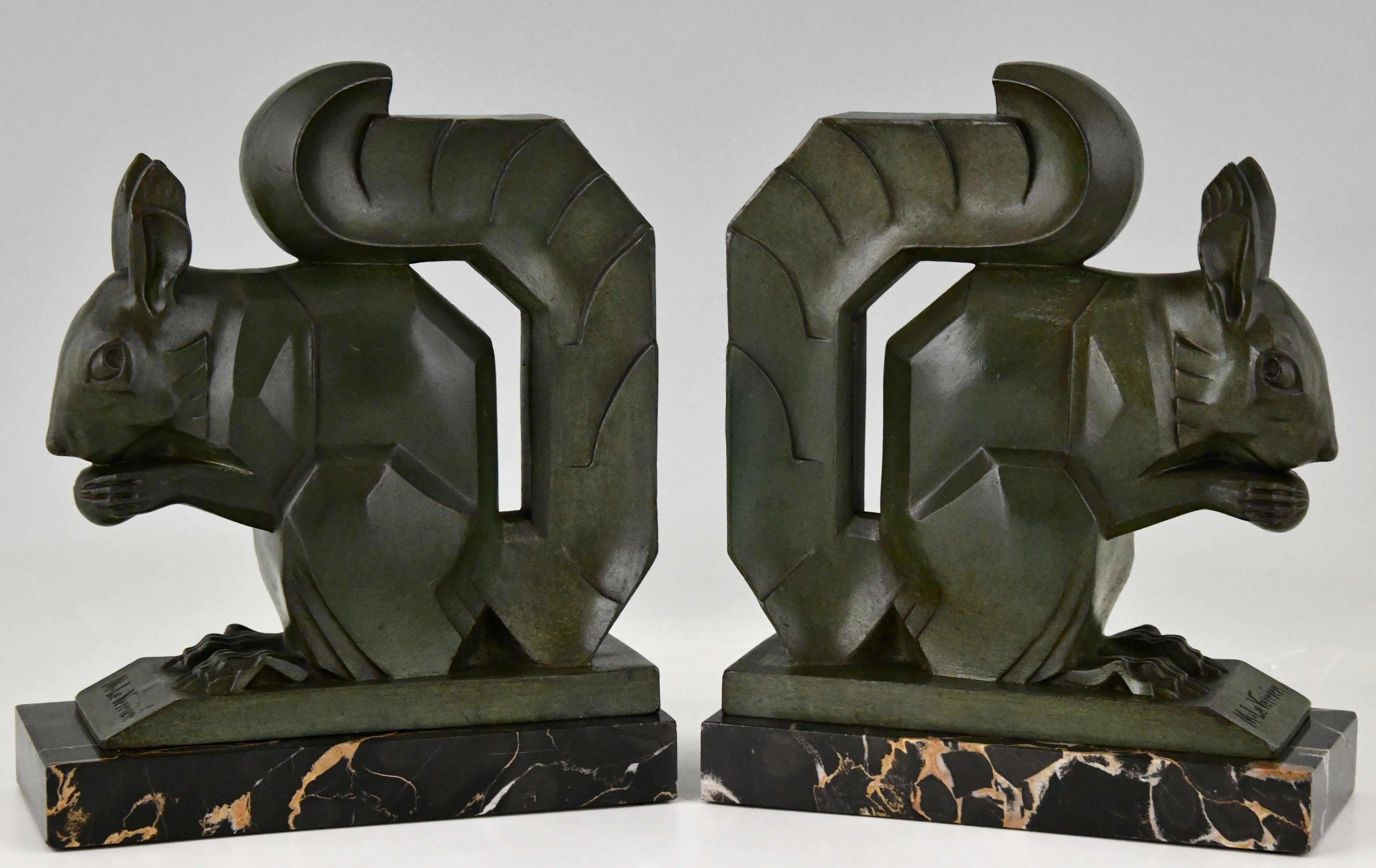 Tall pair of Art Deco squirrel bookends by Max Le Verrier Art metal, dark green patina. Portor marble bases. France 1930. This size is very hard to find. 
Literature:
Art Deco sculpture by Victor Arwas, Academy. Bronzes, sculptors and founders by