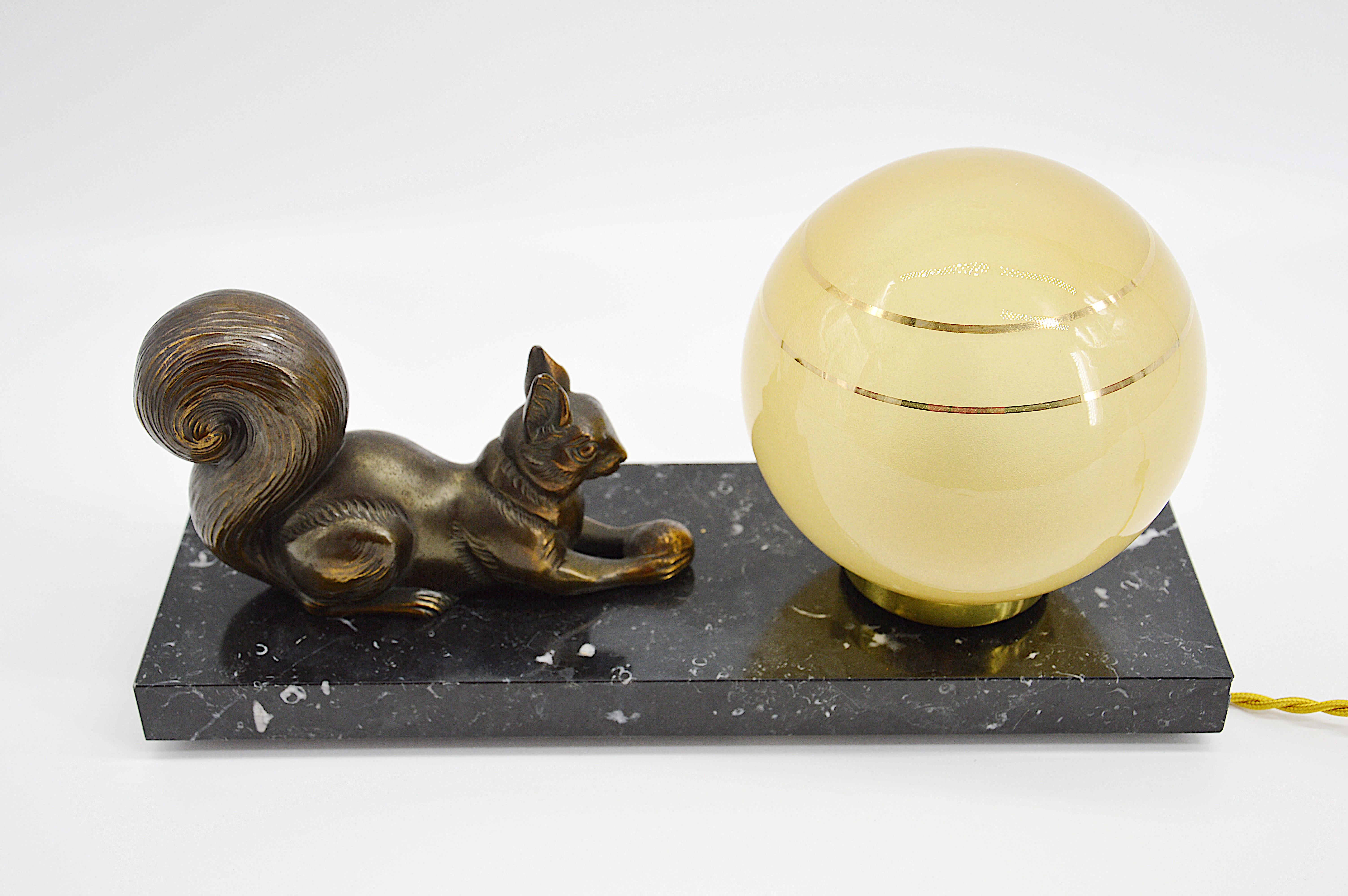 French Art Deco table lamp / night-light, 1920s. Spelter squirrel eating a pine cone. Marble base. Measures: Height 6.1