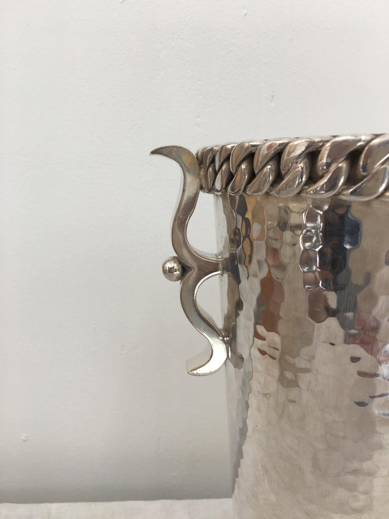 Hammered Bronze Silver Plated Wine Bottle Bucket signed underneath by Jean Despres.
Style Art Deco .
Elegant and precious design by the well knowned creator Jean Despres, the thick Chain around the Top is his favorit détail design.
 
