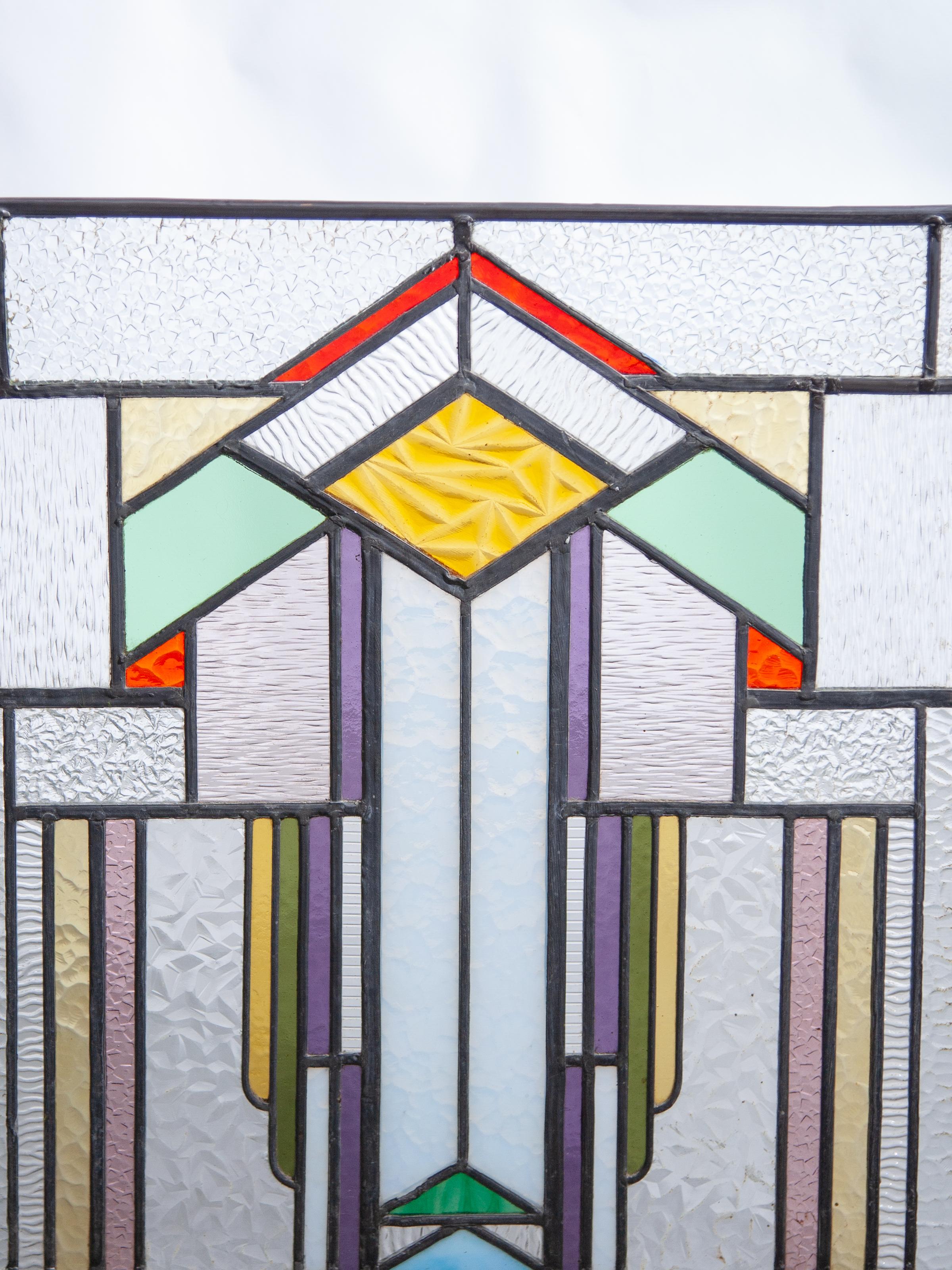 Art Deco hanging stained glass window a decorative linear symmetry with a mathematical and geometric touch. It’s dramatic, eye catching, and gives a distinct feel and flair to a room, whether in the furnishings or the artwork.
Geometric shapes and