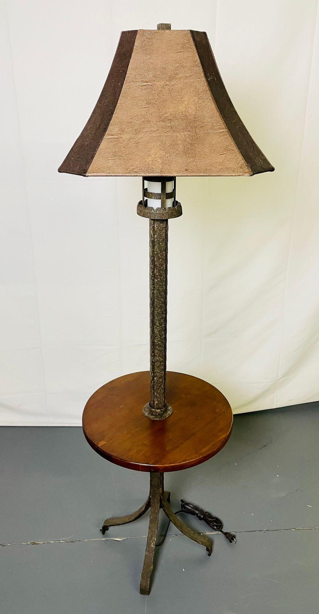 Mid-Century Modern standing floor, table lamp, Oscar Bach
 
Attributed to Oscar Bach, this stunning floor lamp has a tastefully rustic, hammered metal surface treatment and coordinating shade of hand-tooled leather. At the top is a gothically