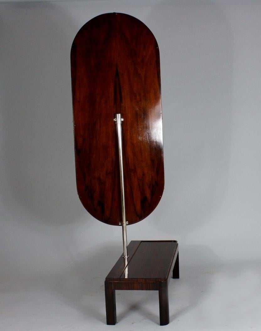Art Deco standing rotable mirror from the 1930s. Material of the base is zebrawood veneer and walnut. The mirror is placed on a rotable chrome plated bar.