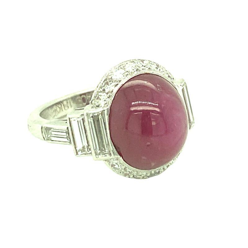 One Art Deco star ruby and diamond platinum and 18K white gold ring centering one bezel set, oval cabochon cut star ruby weighing 11 ct. with strong asterism with AGL Certificate No. CS1079330 stating Burmese origin and no heat treatment. Surrounded
