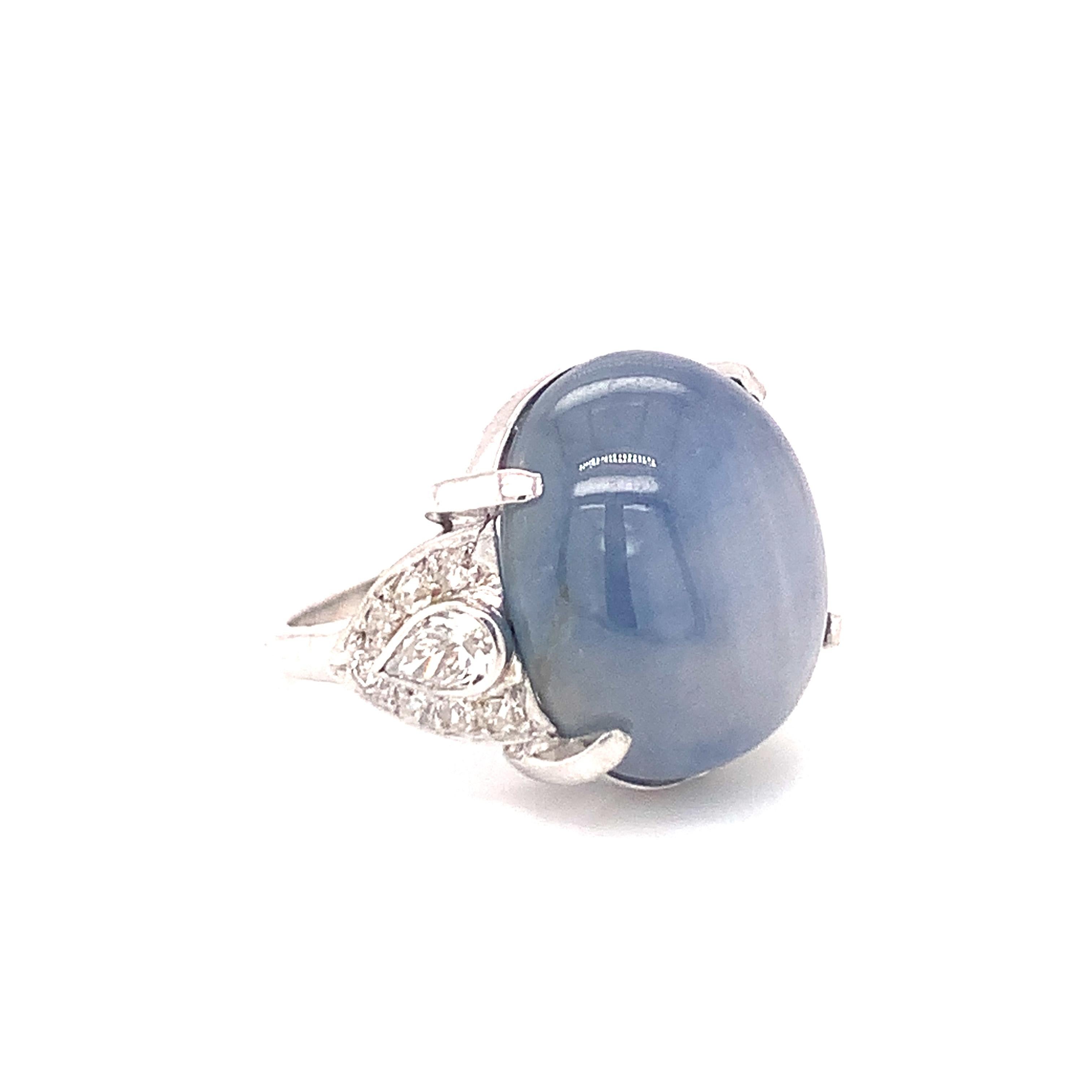 Art Deco star sapphire and diamond platinum ring featuring one oval cabochon cut, grayish blue star sapphire weighing 36 ct. further accented by old European, single round cut and pear brilliant diamonds totaling 1.25 ct. with H-I color and SI-1