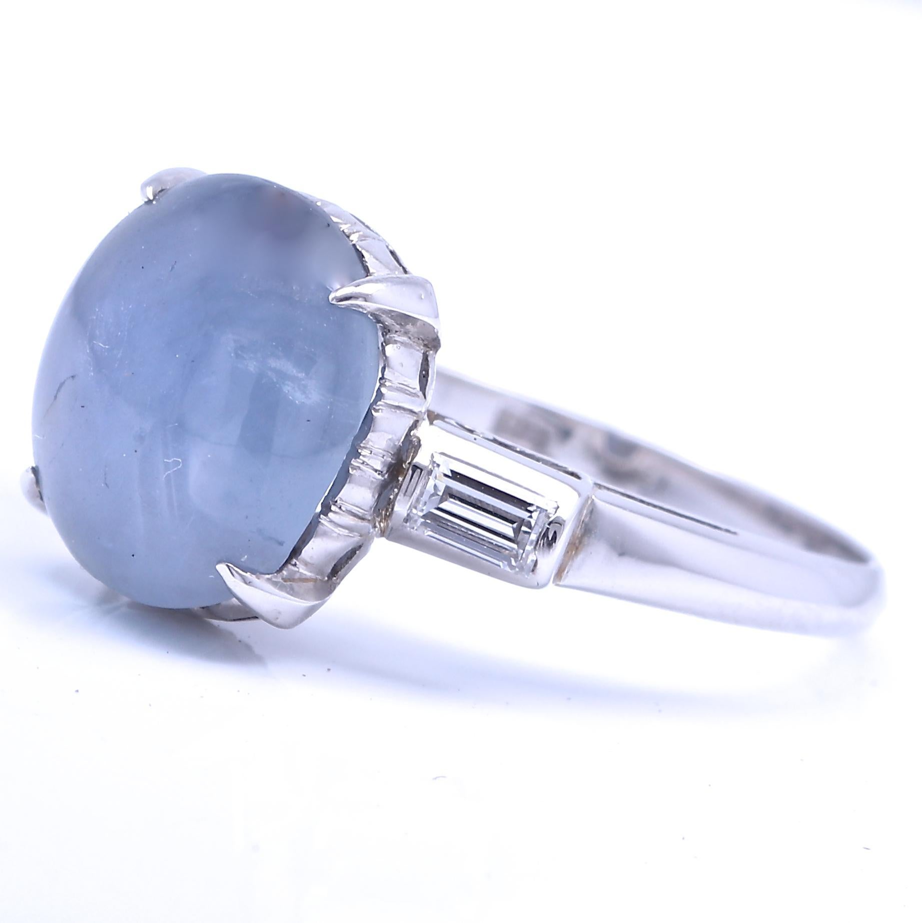 Subtly stunning, this Art Deco ring features a 6.55 carat star sapphire and two baguette cut diamonds graded G-H color VS+ clarity. Circa 1920. Size 6 3/4 and comes with complimentary sizing if needed. 
Jack Weir & Sons Flawless Protection Plan: 
7