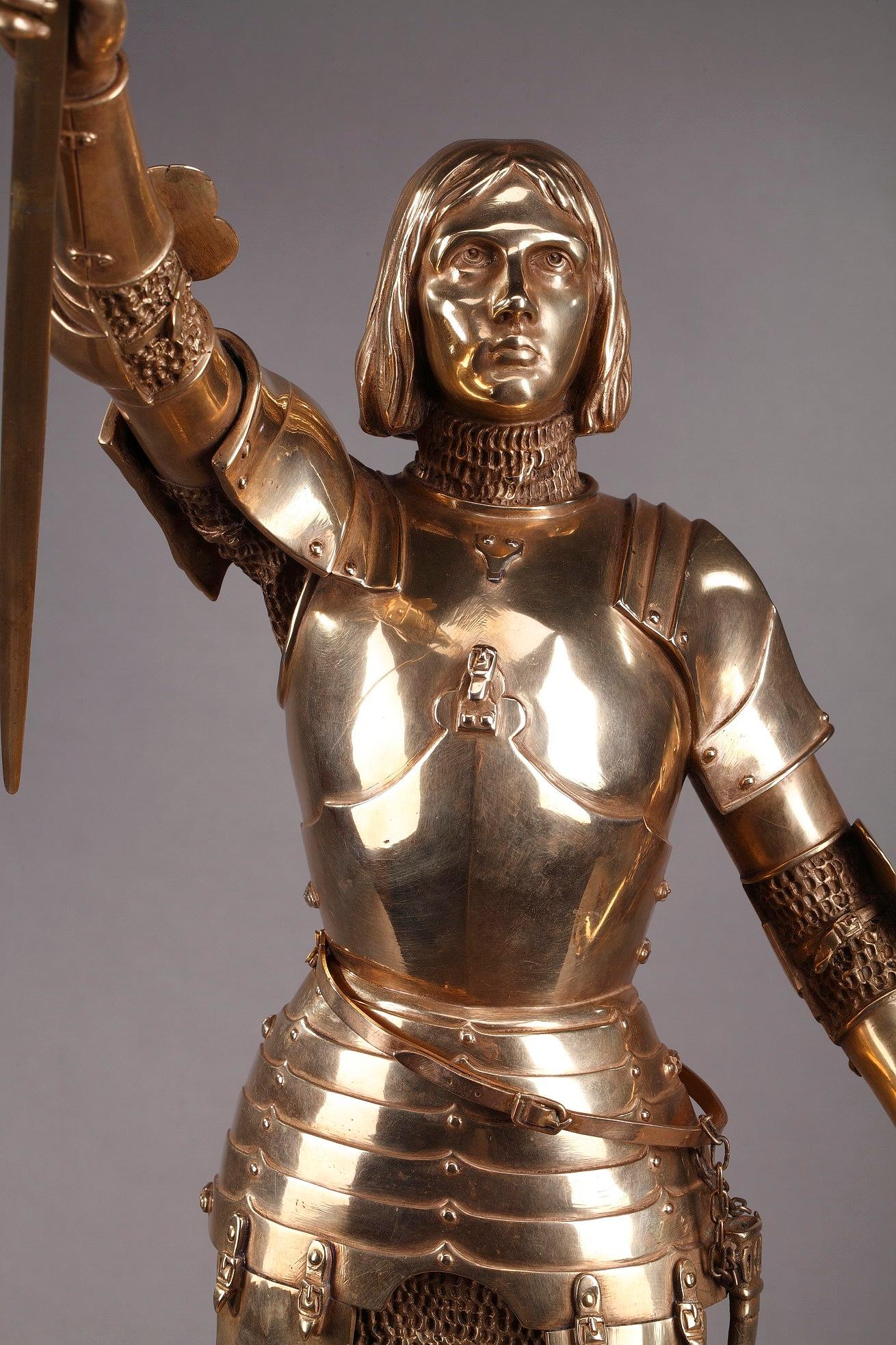 Art Deco statue crafted in gilt bronze featuring Joan of Arc by Gustave Poitvin. Joan of Arc or Jeanne d'Arc (1412-1431), nicknamed The Maid of Orléans, is a historical figure and heroine of France for her role during the Hundrer Years' War