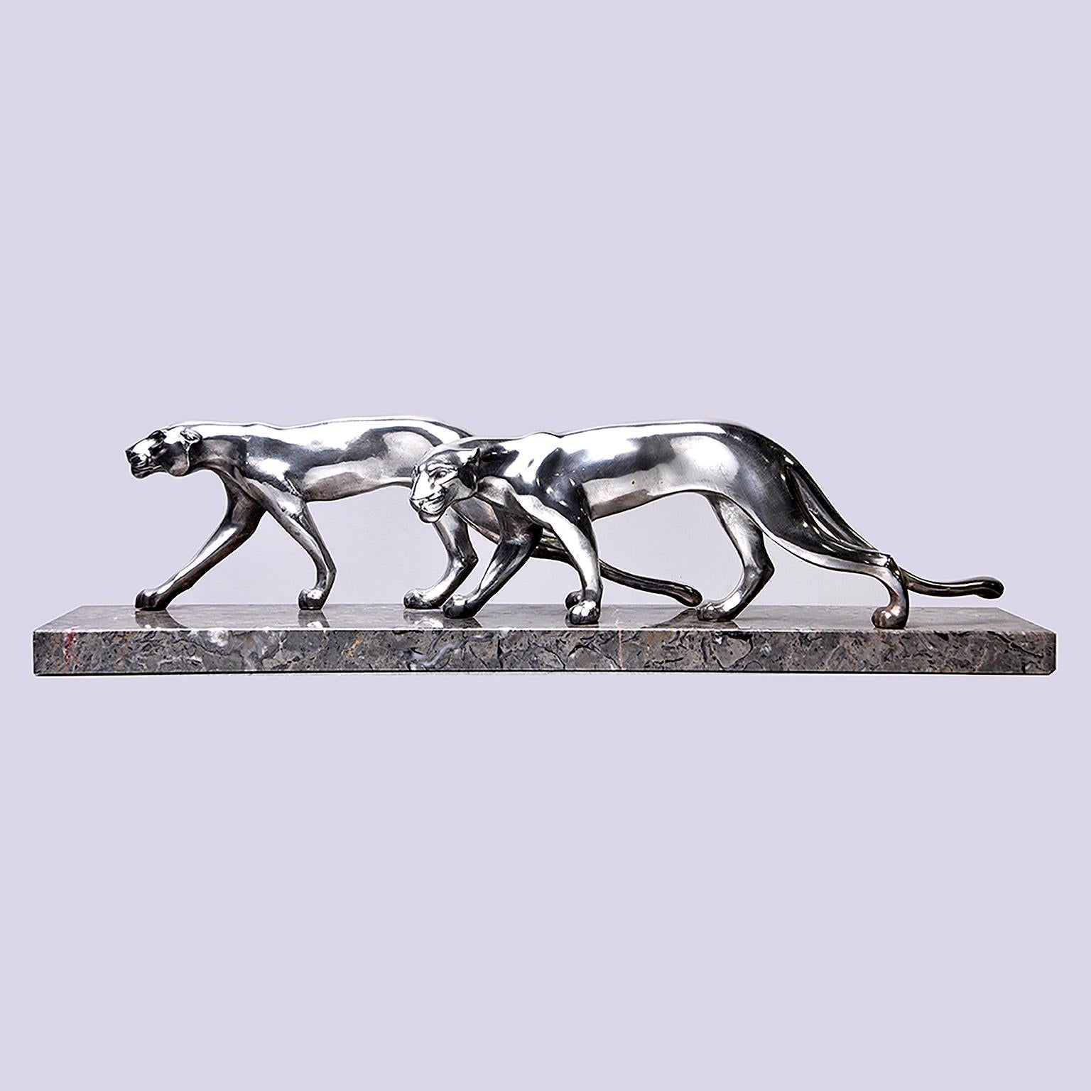 Statue of two sleek panthers, circa 1930s. Unsigned, unmarked. Believed to be French. Appears to be cast metal with polished chrome finish on marble base. Excellent vintage condition.