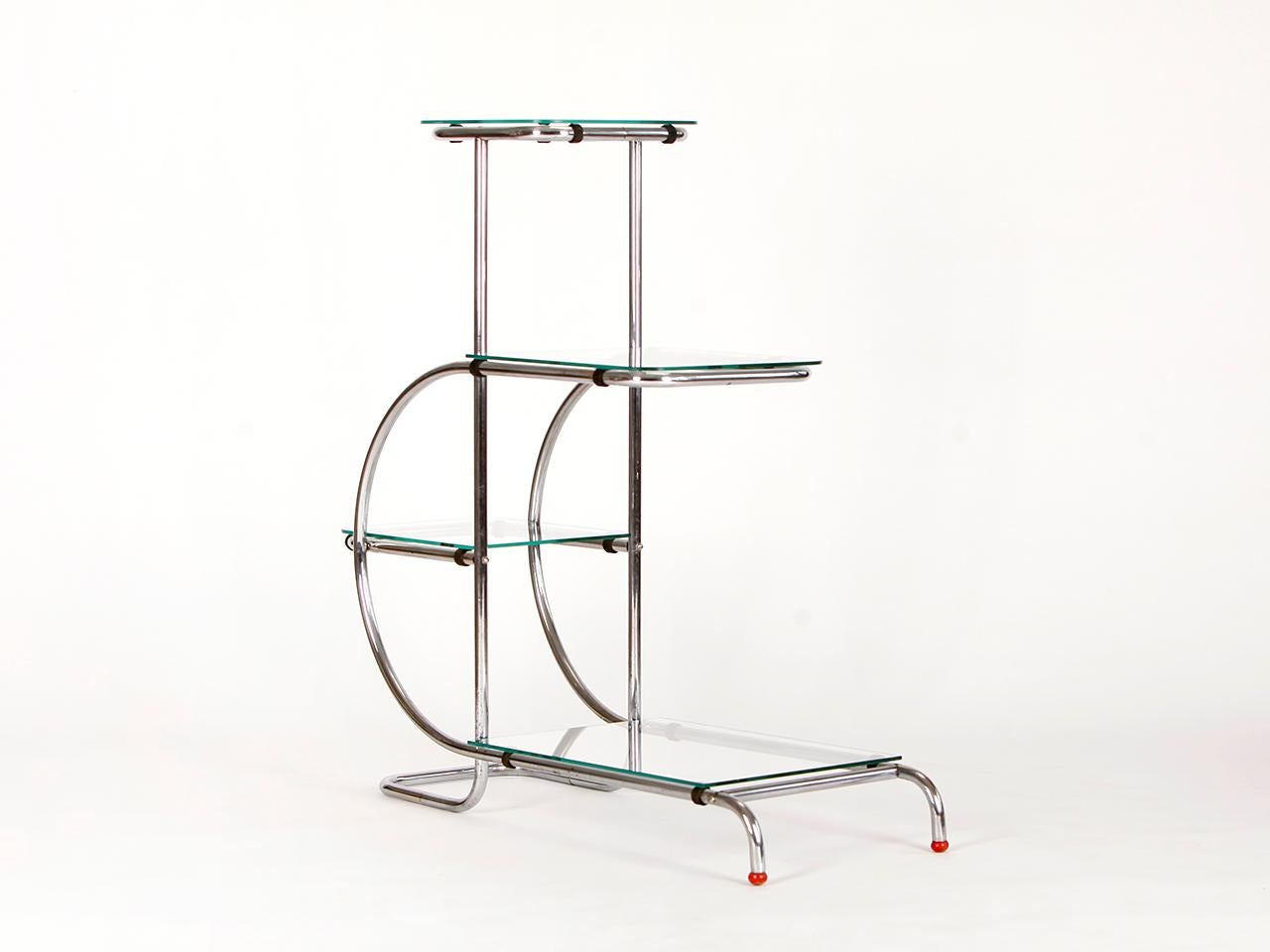 This étagère, with a frame of bent steel tube and glass shelves, was made in the 1930s in the Czech Republic. Original chromium plating in a very nice original condition. Glass plates renewed.

 