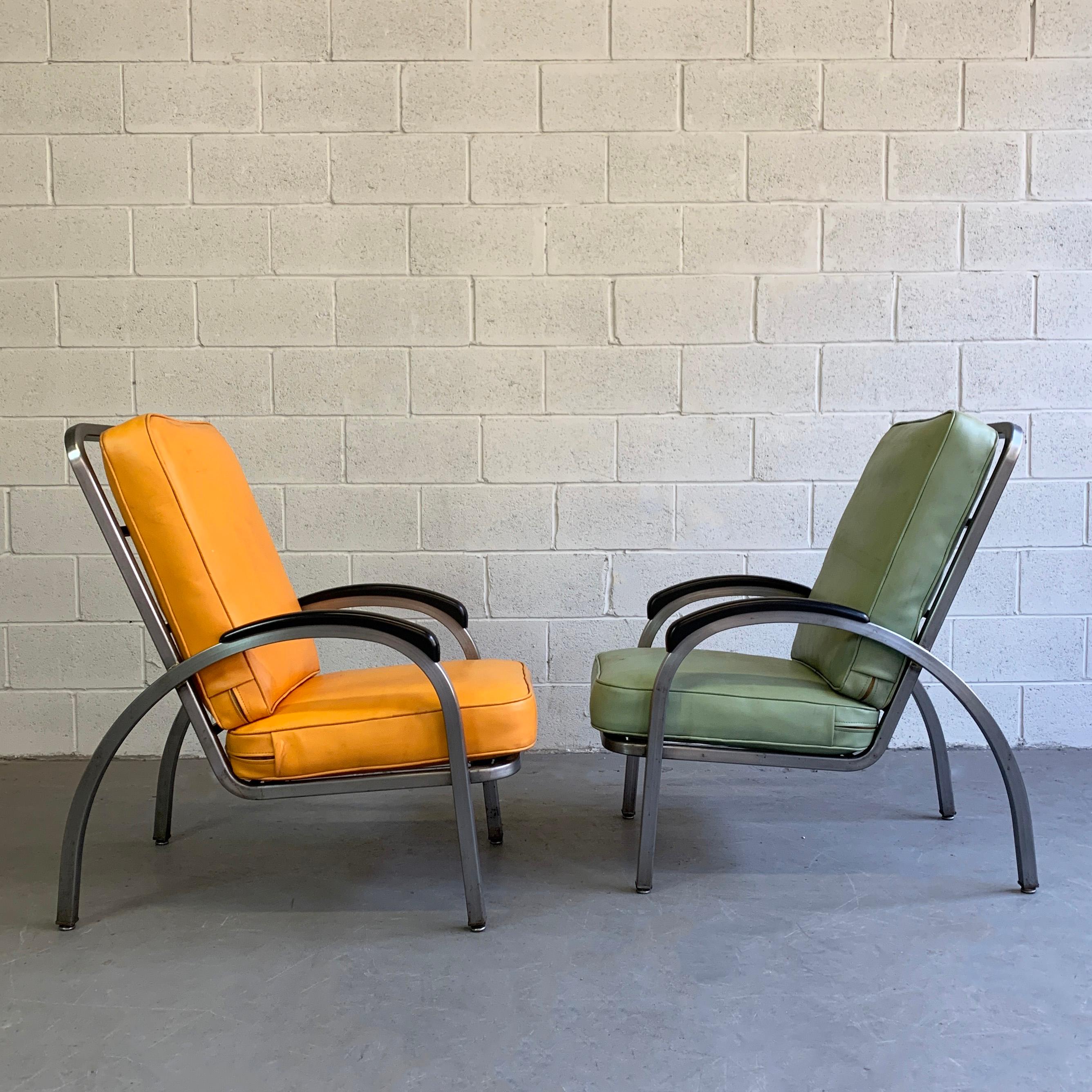 Pair of high back, Art Deco, machine age, armchairs by Norman Bel Geddes for Simmons Company Furniture feature newly brushed steel frames with Bakelite armrests and vinyl covered cushions.