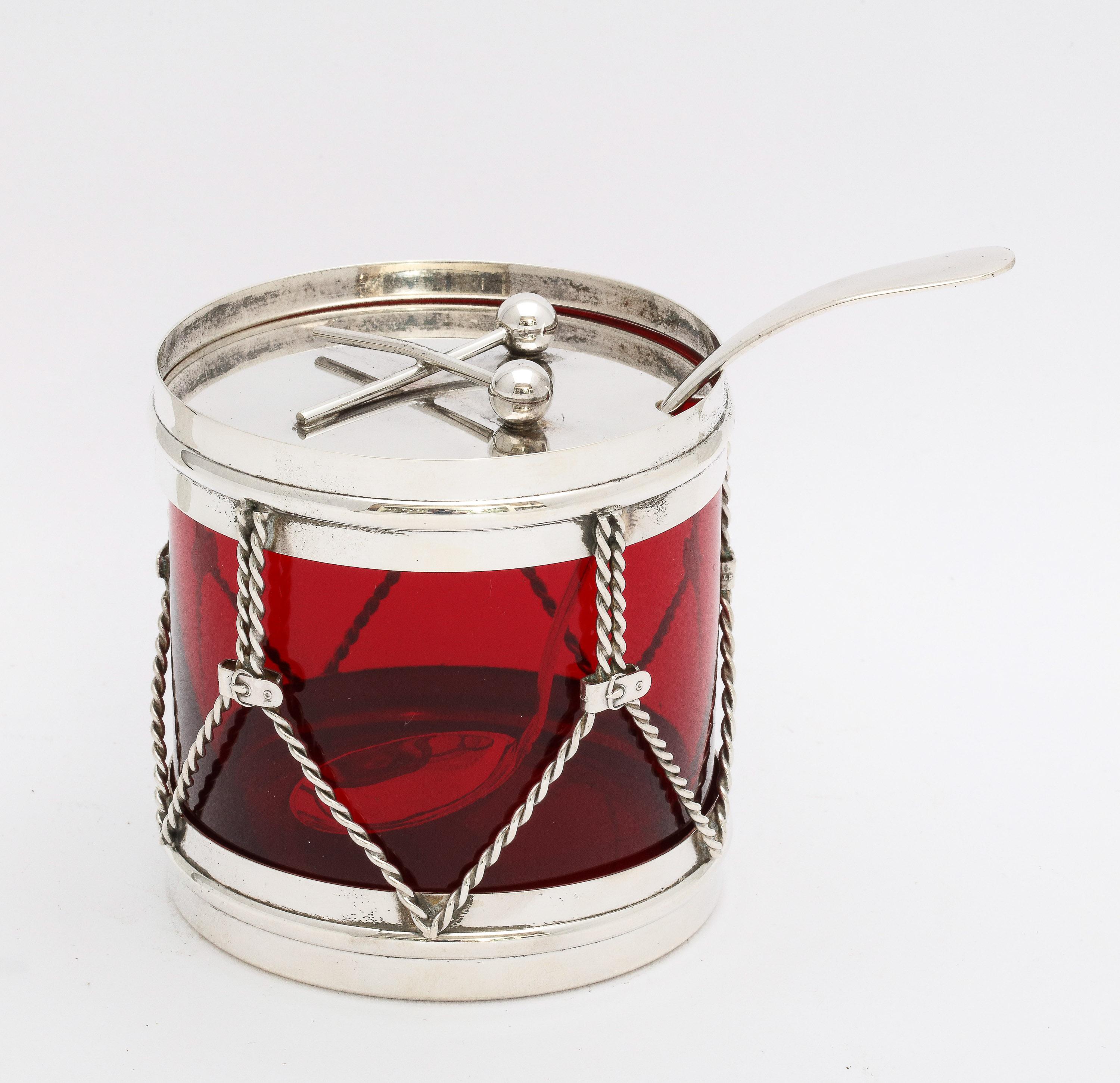 Art Deco period, sterling silver and ruby glass, drum-form condiments jar with original sterling silver spoon, R. Blackinton and Co., No. Attleboro, Mass., Ca. 1930's. Measures 3 1/8 inches high x 3 1/4 inches diameter. Sterling silver spoon