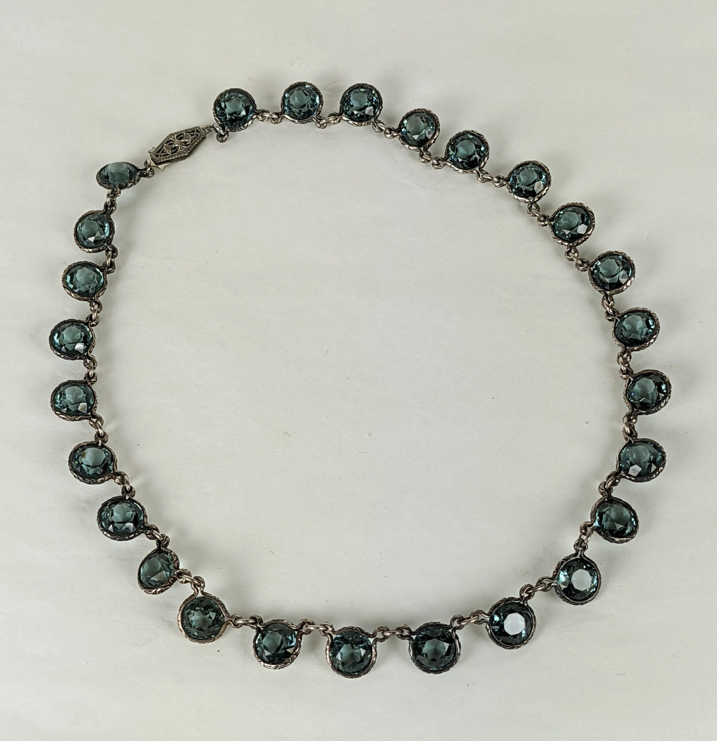 Art Deco Sterling Channel Crystal Necklace set in sterling with faux blue zircon crystals. Unusual sterling settings and links are decorated with etched scroll work and pair nicely with the deep blue of the stones. 1920's USA.  15.5