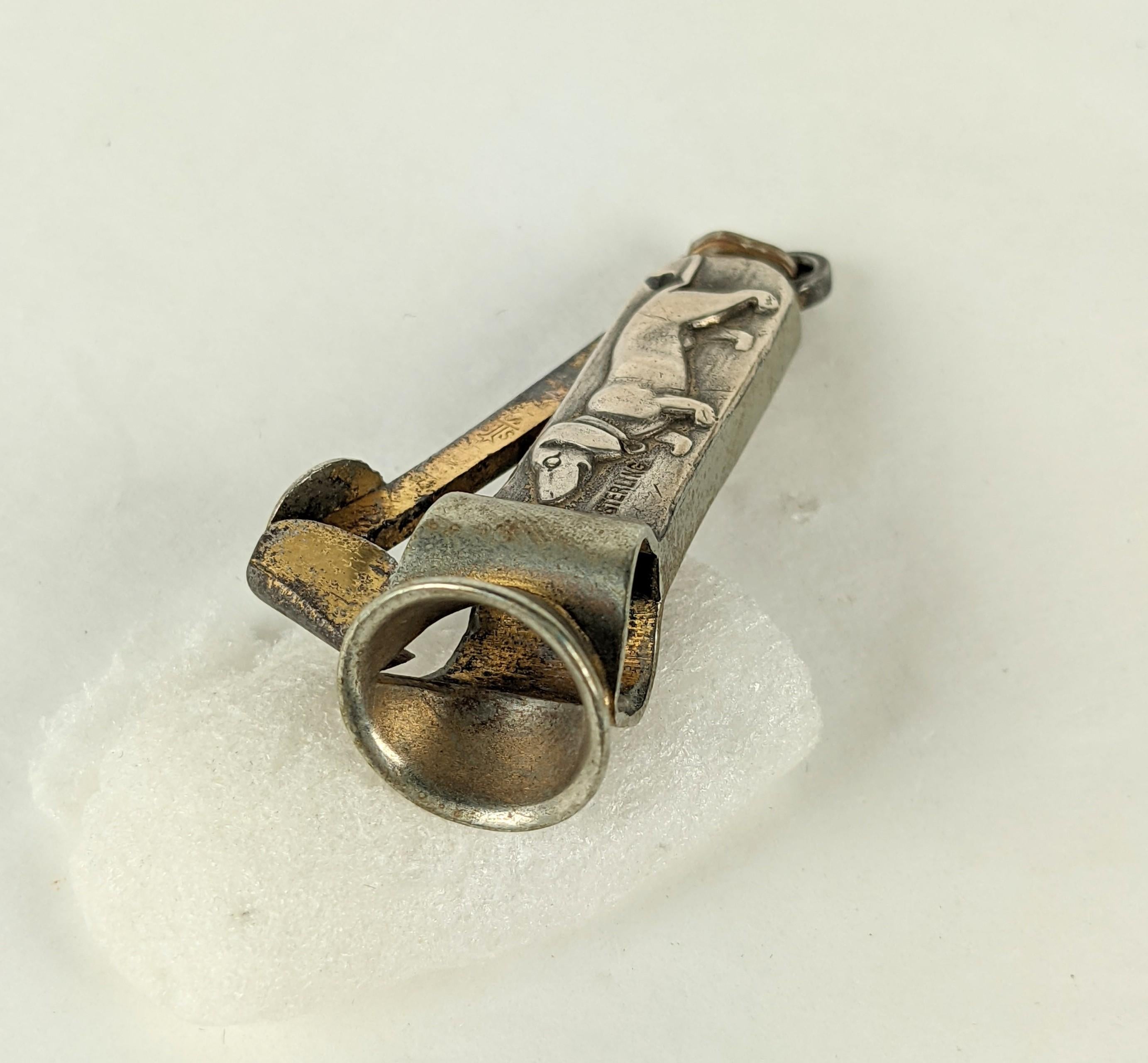 Charming Art Deco Sterling Daschund Cigarette/Cigar Cutter. Mechanism is clad in sterling silver with dog motif, with brass bale. Works well as a pendant as well.
1930's USA. Measures 2
