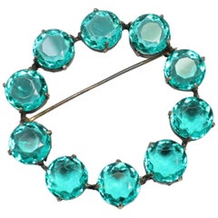 Art Deco Sterling 
Emerald Crystal Circular Brooch, 1930s