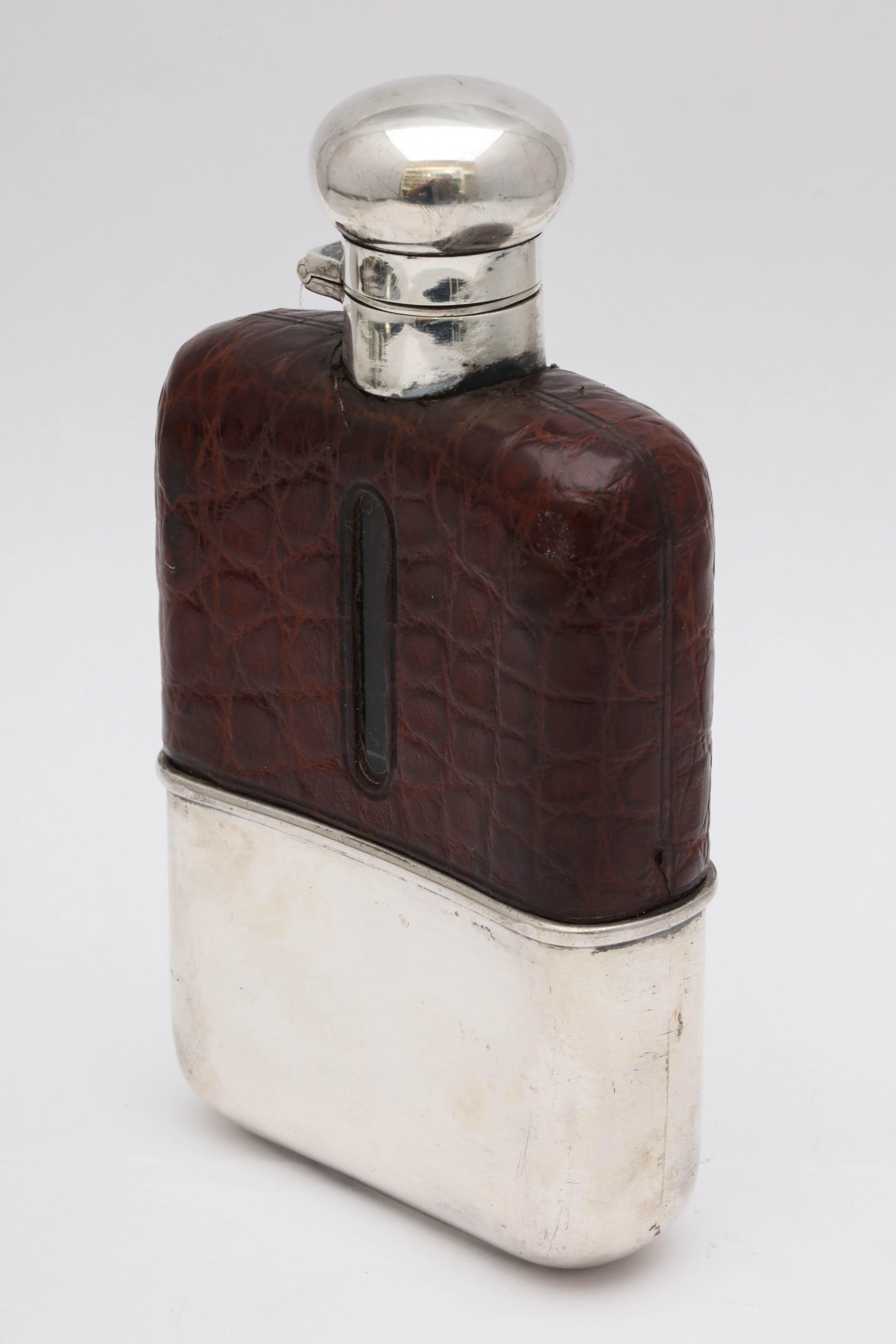 Art Deco, sterling silver and alligator-mounted glass flask with hinged lid and removable sterling silver drinking cup, Chester, England, 1917, Hamilton and Company - makers. Opening in alligator mount allows one to see how much liquid is left in