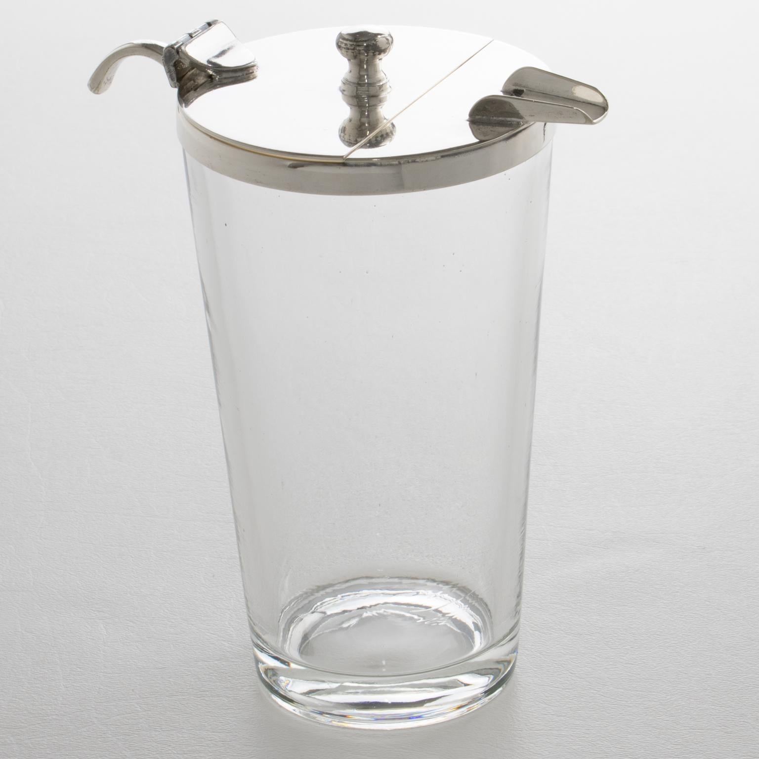 Questa splendida caraffa per Martini o cocktail in stile Art Déco è stata realizzata in Inghilterra intorno al 1930. Questo accessorio da bar ha un design elegante, completo di un contenitore in cristallo modellato ornato da un colino in argento