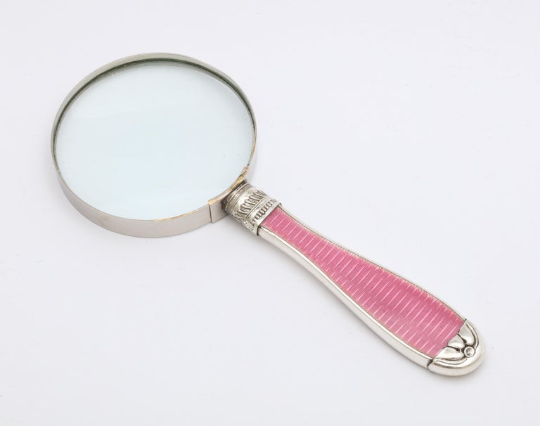 Art Deco, sterling silver and deep pink guilloche enamel-mounted magnifying glass, Birmingham, England, 1921, H. Matthews - maker. Measures 7 1/4 inches long x 3 1/8 inches diameter across glass which has a metal surround. Enamel is on one side of